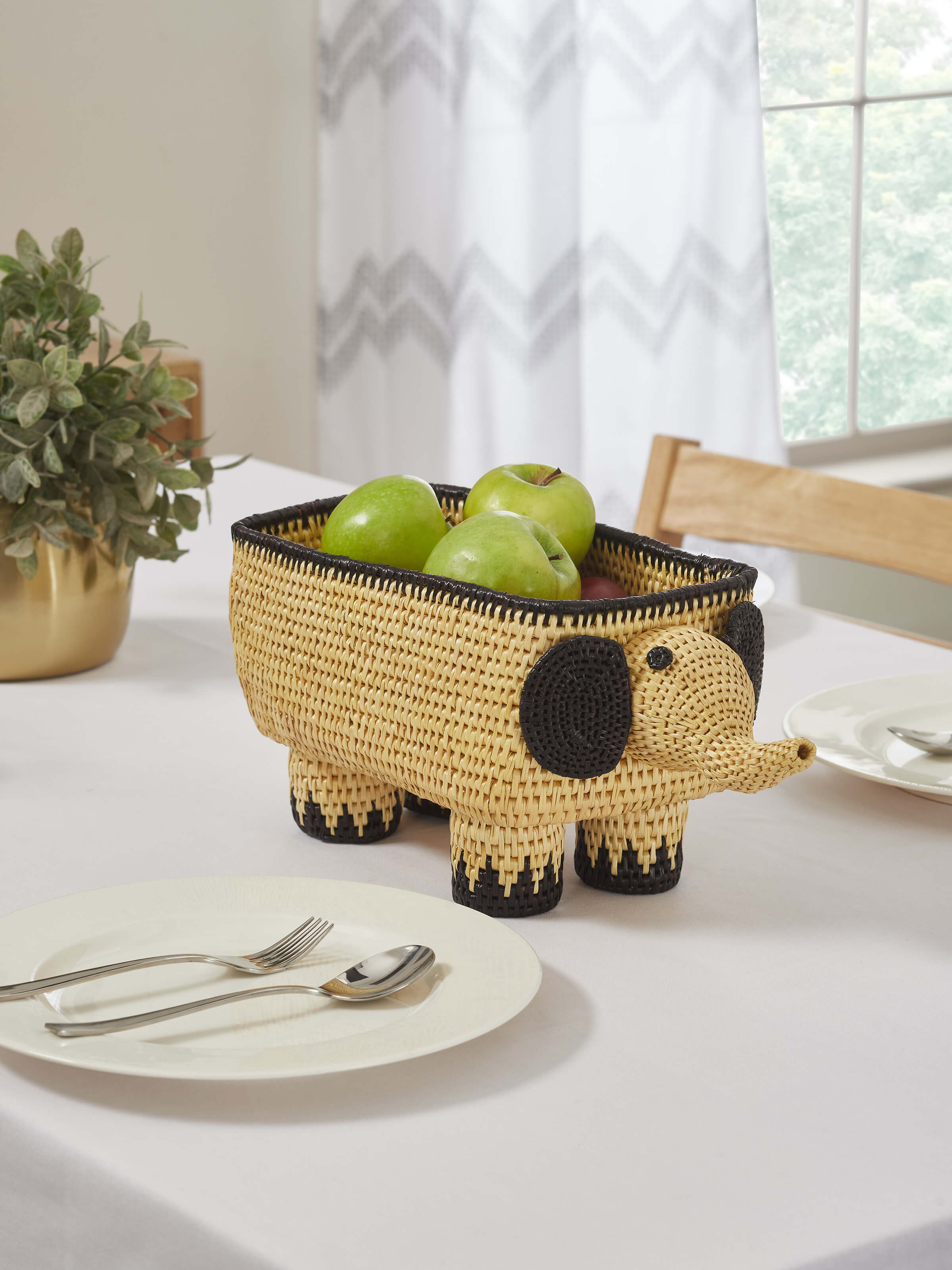 Side view of Sikki Grass Fruit Bowl in white highlighting the bowl's shape and weaving details.
