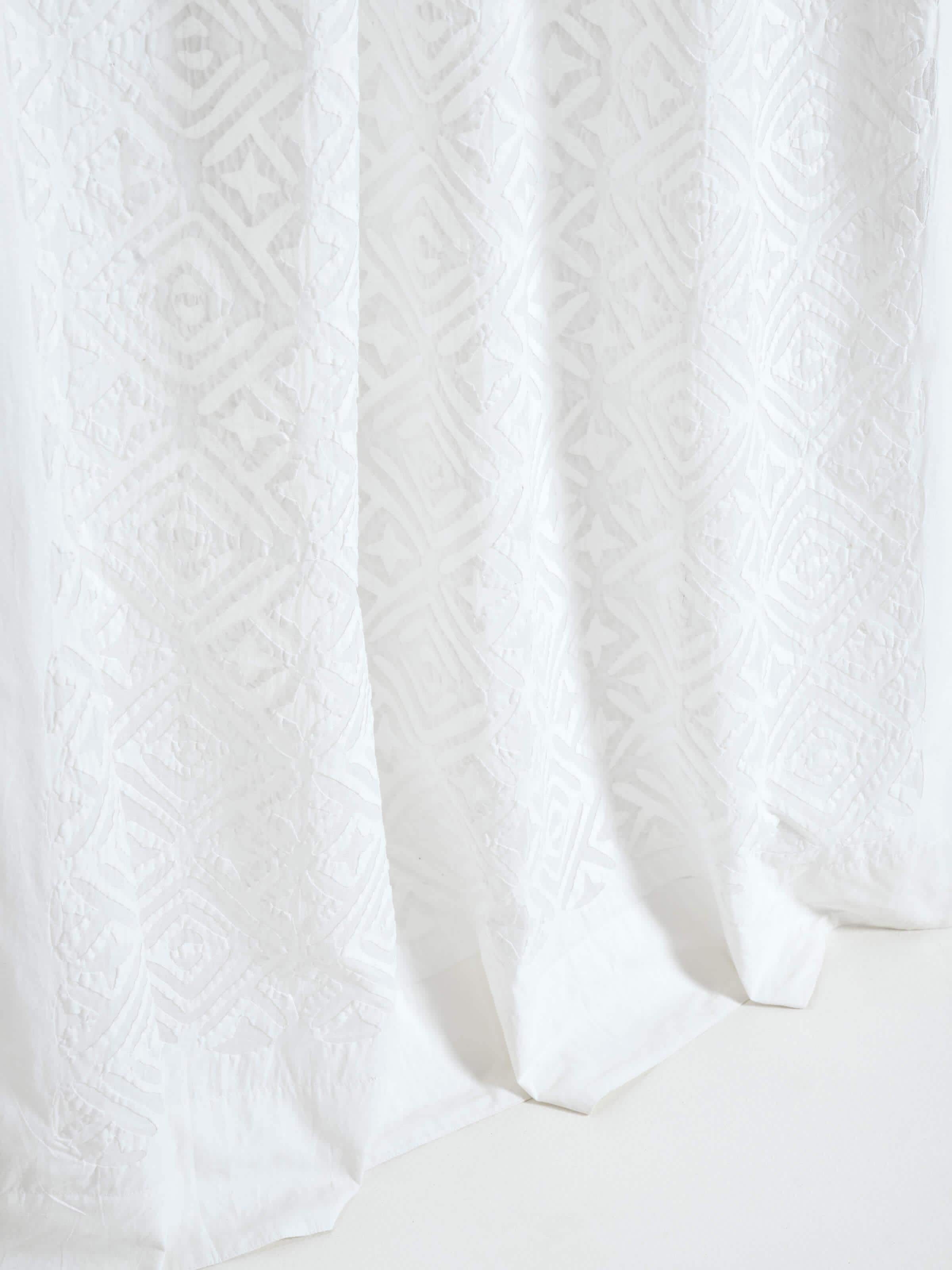 Close-up of Mandana White Trellis sheer curtain showing the cotton fabric texture and applique details