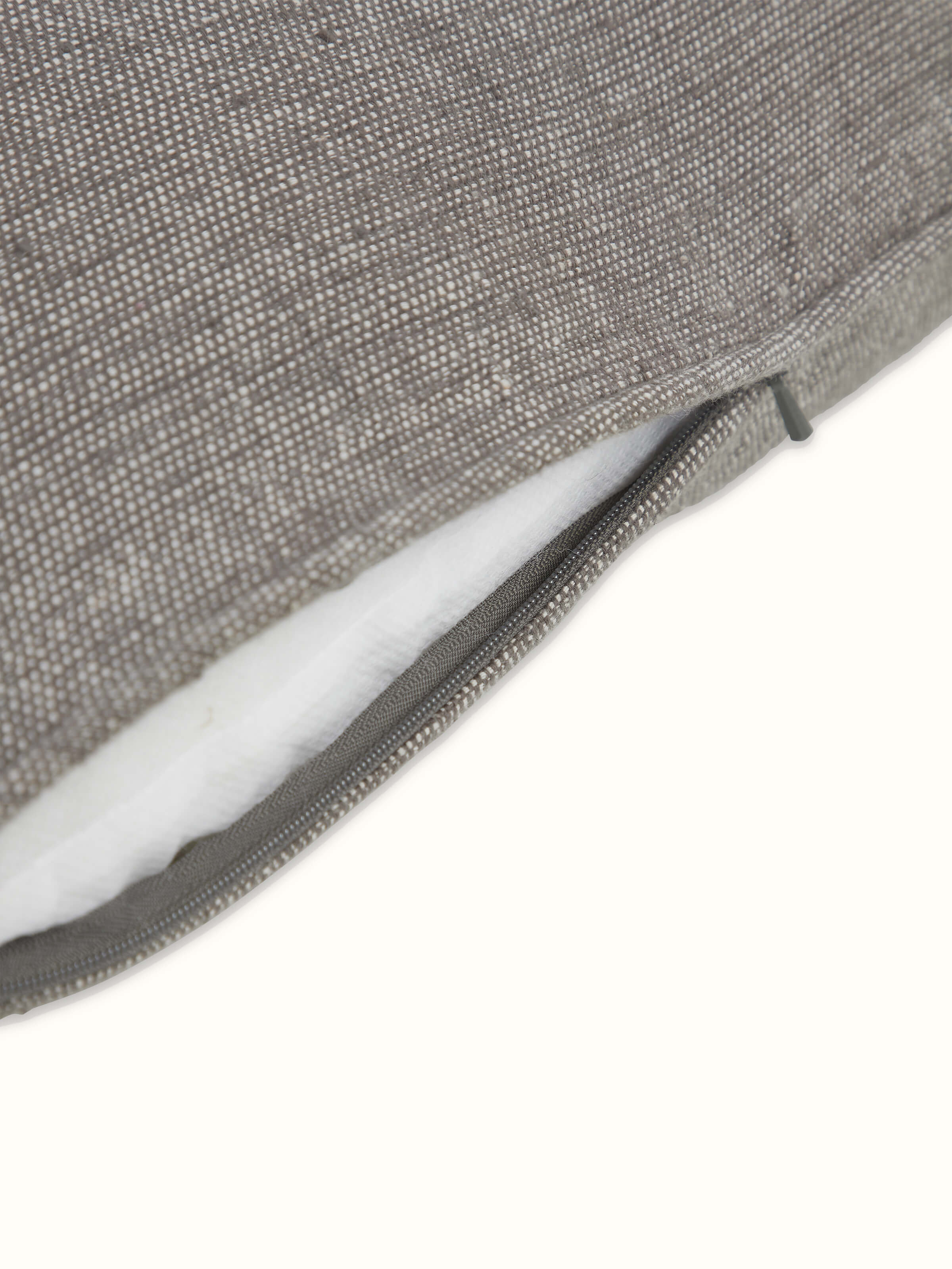 Angled view of Anek coffee mangal cotton Bhujodi handloom cushion cover, displaying the cushion's pattern and rich color.