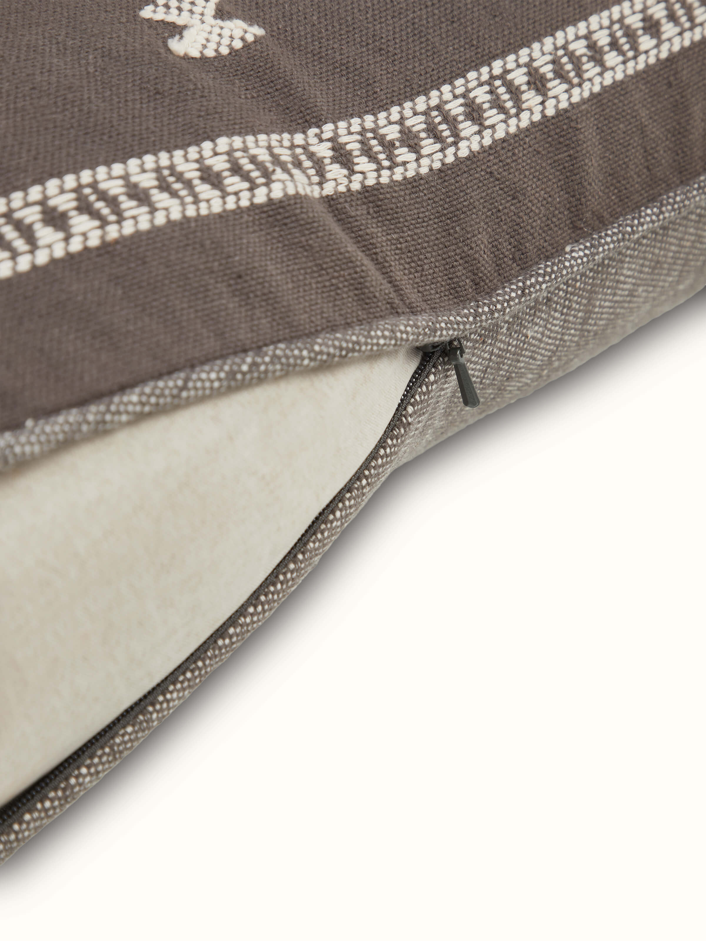 Angled close-up displaying artisanal Bhujodi weave and fine cotton texture.