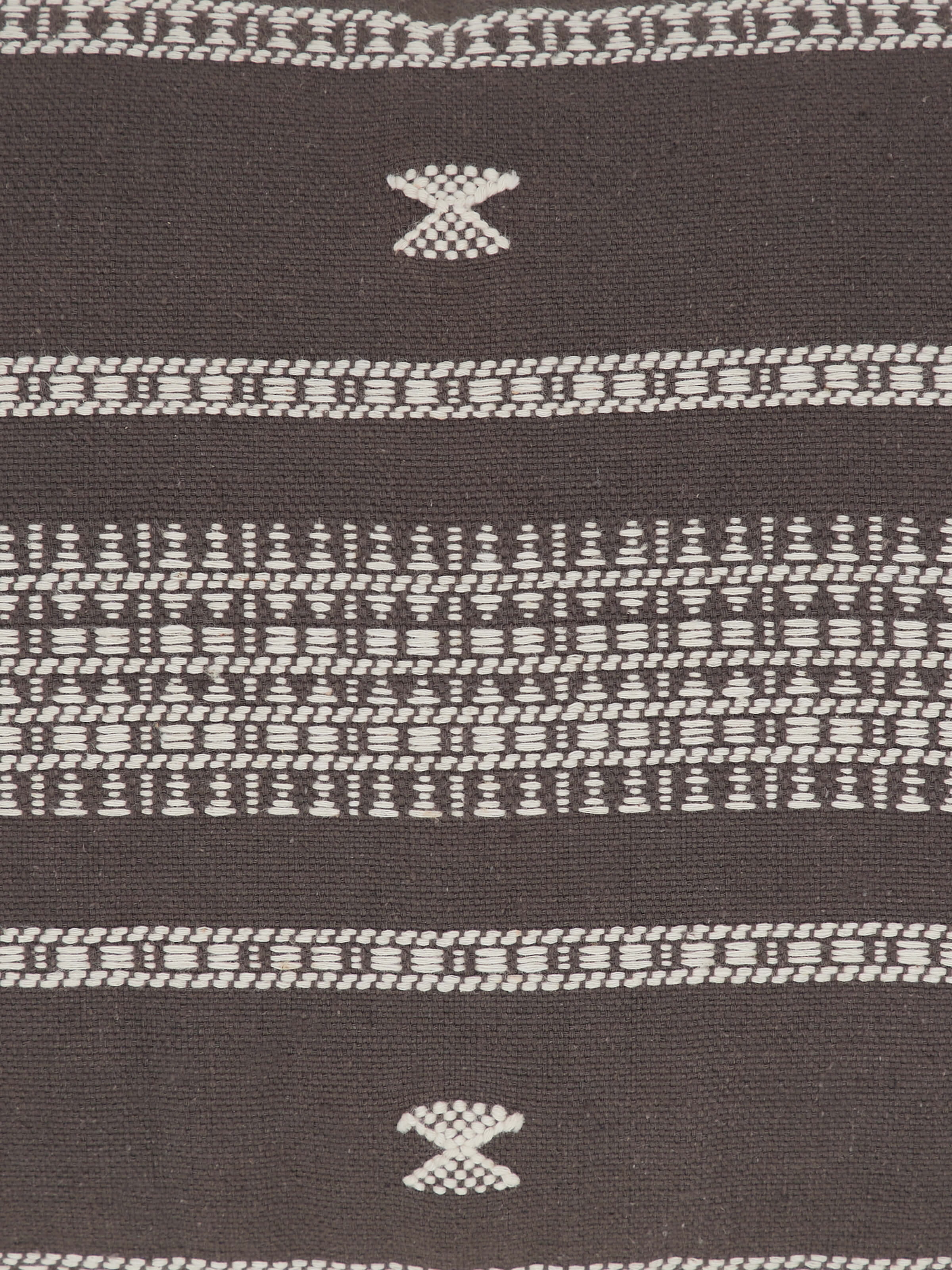 Detail shot of cushion cover corner highlighting handloom pattern and fabric finish.