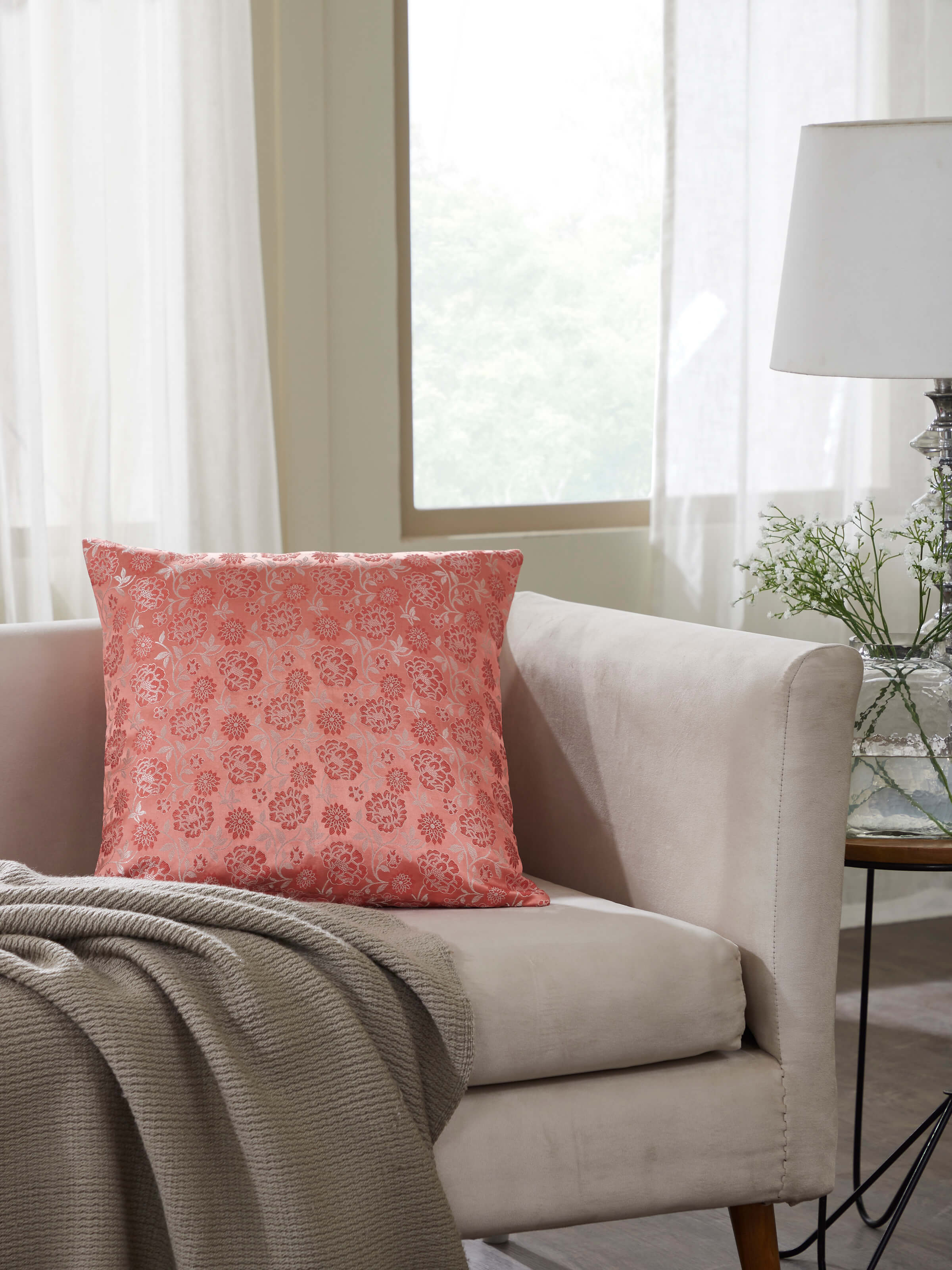 Front view of Jangala peach jaal silk brocade Banarasi handloom cushion cover showcasing its elegant pattern and texture.