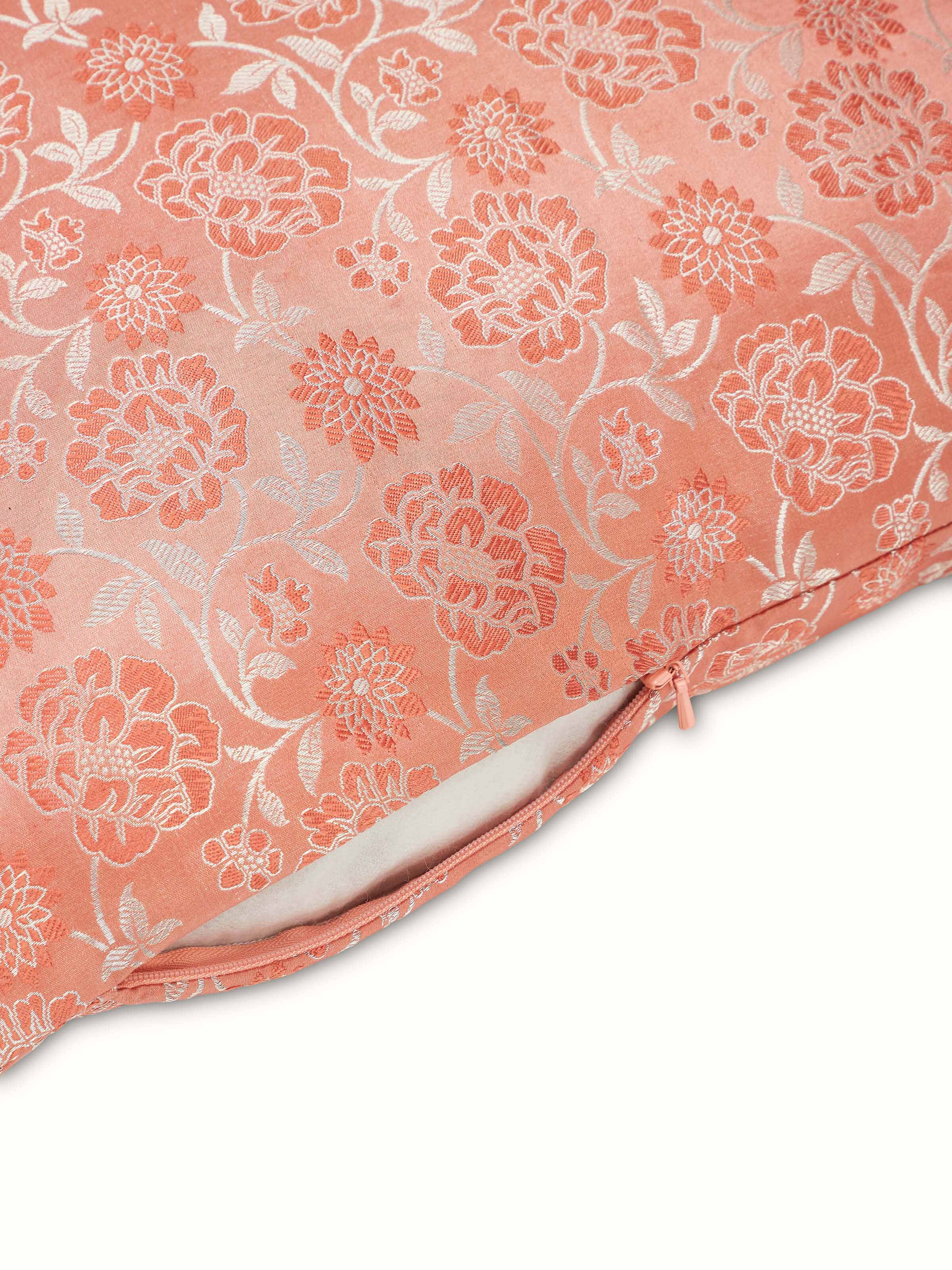 Close-up of Jangala peach jaal silk brocade Banarasi handloom cushion cover focusing on the detailed embroidery and fabric.