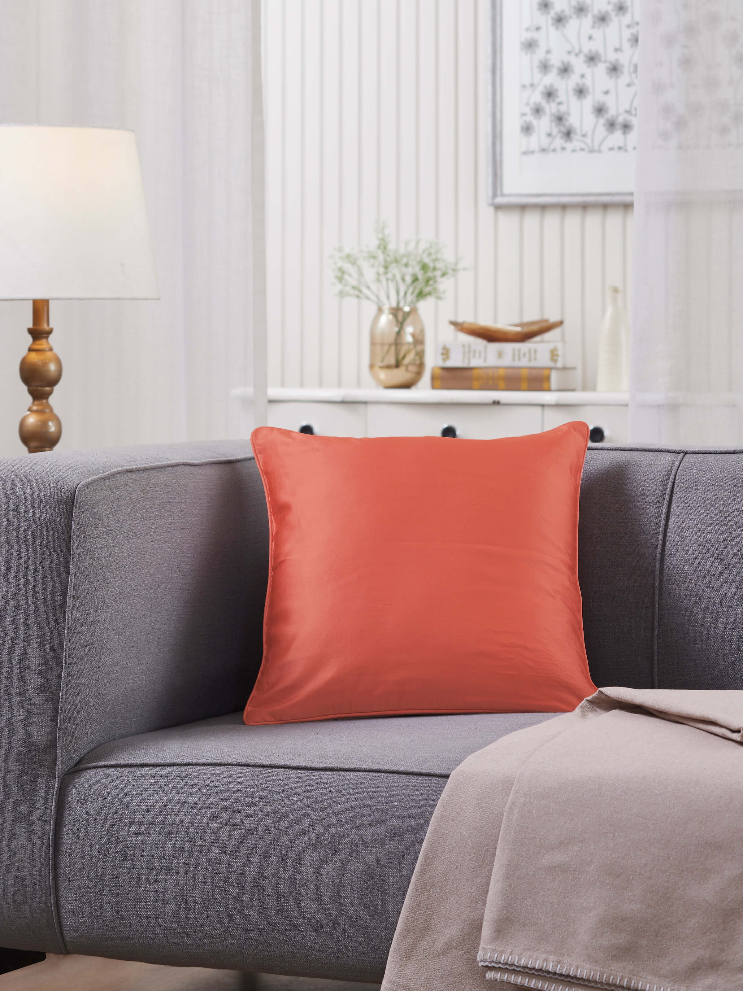 Side view of Malya Peach Solid Silk Satin Banarasi Handloom Cushion Cover highlighting the smooth texture and handloom craftsmanship