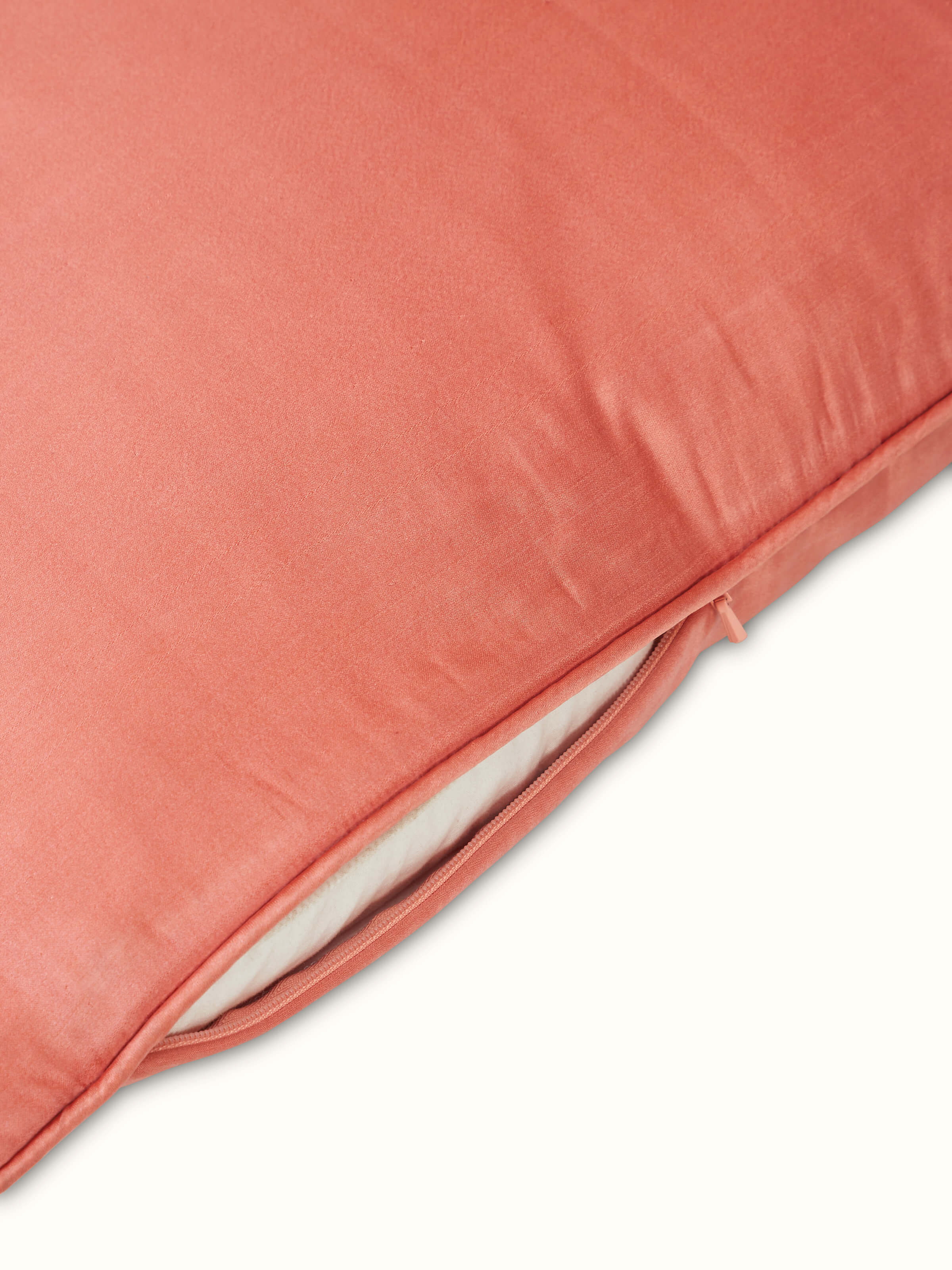 Close-up of Malya Peach Silk Satin Banarasi Cushion Cover showing the fine weave and subtle sheen