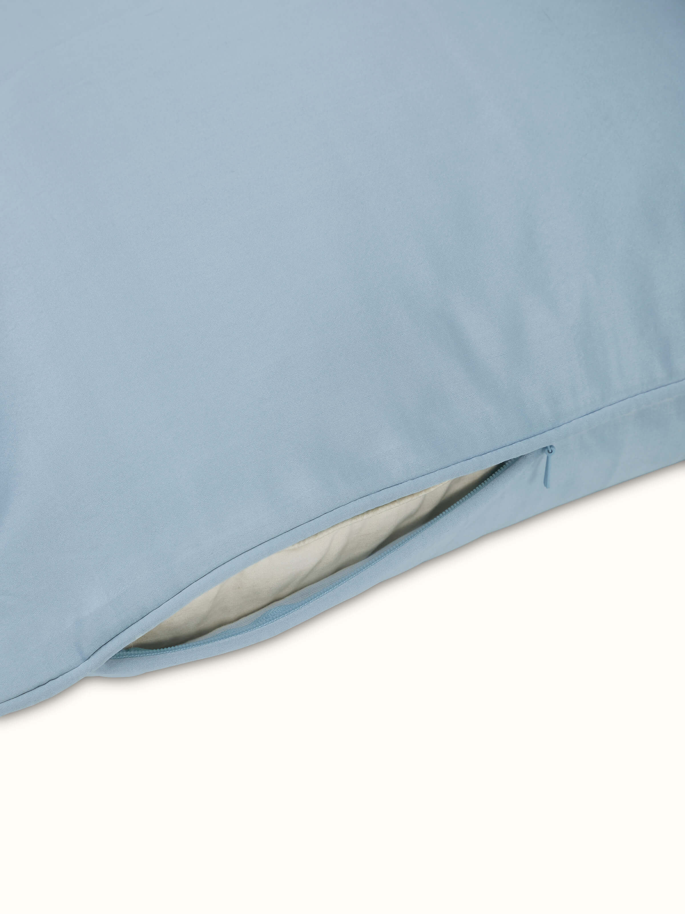 Close-up of aqua Banarasi silk cushion cover showing lustrous satin texture and handwoven detailing