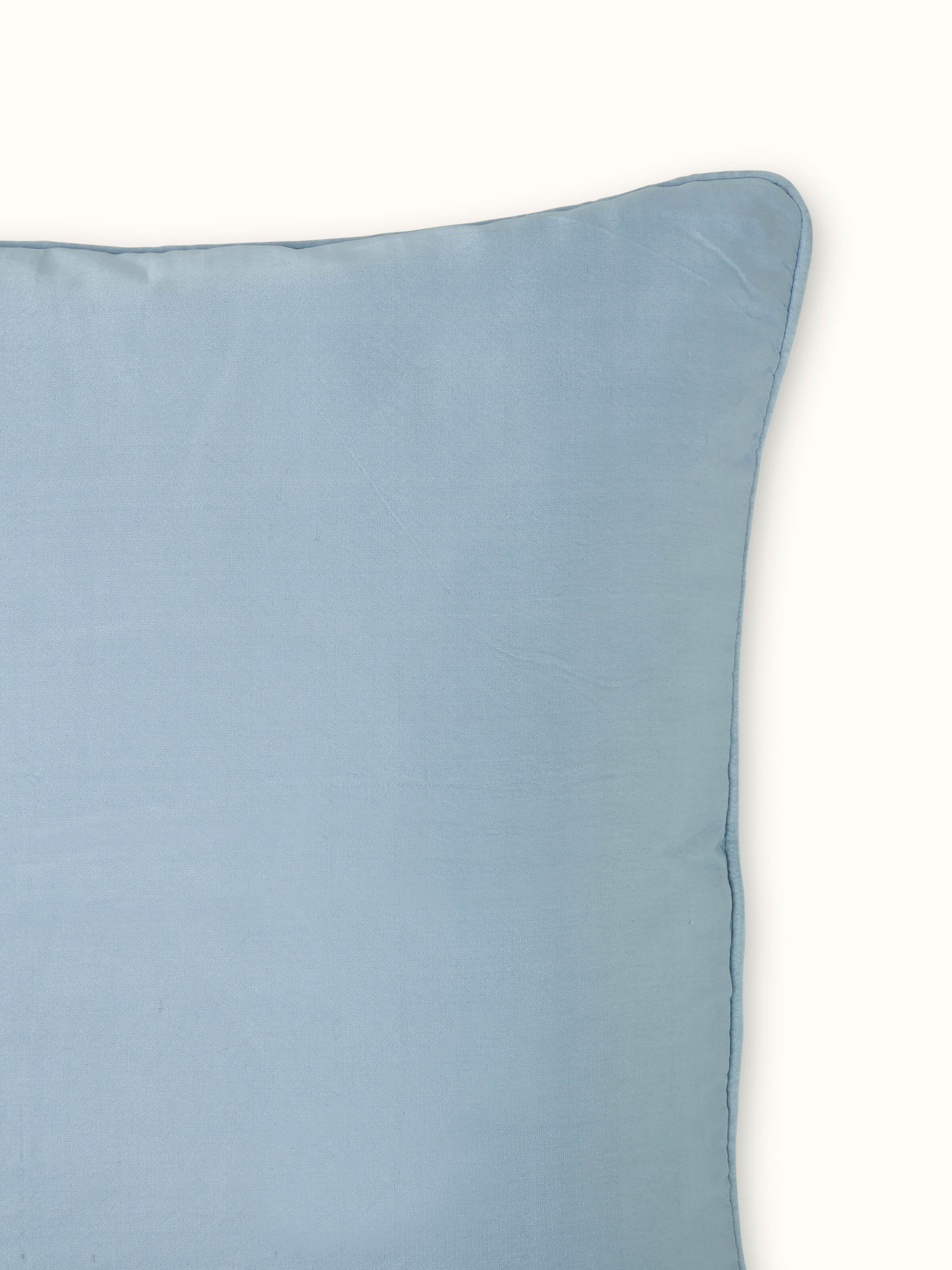 Detail shot of cushion cover edge highlighting fine stitching and premium silk handloom craftsmanship