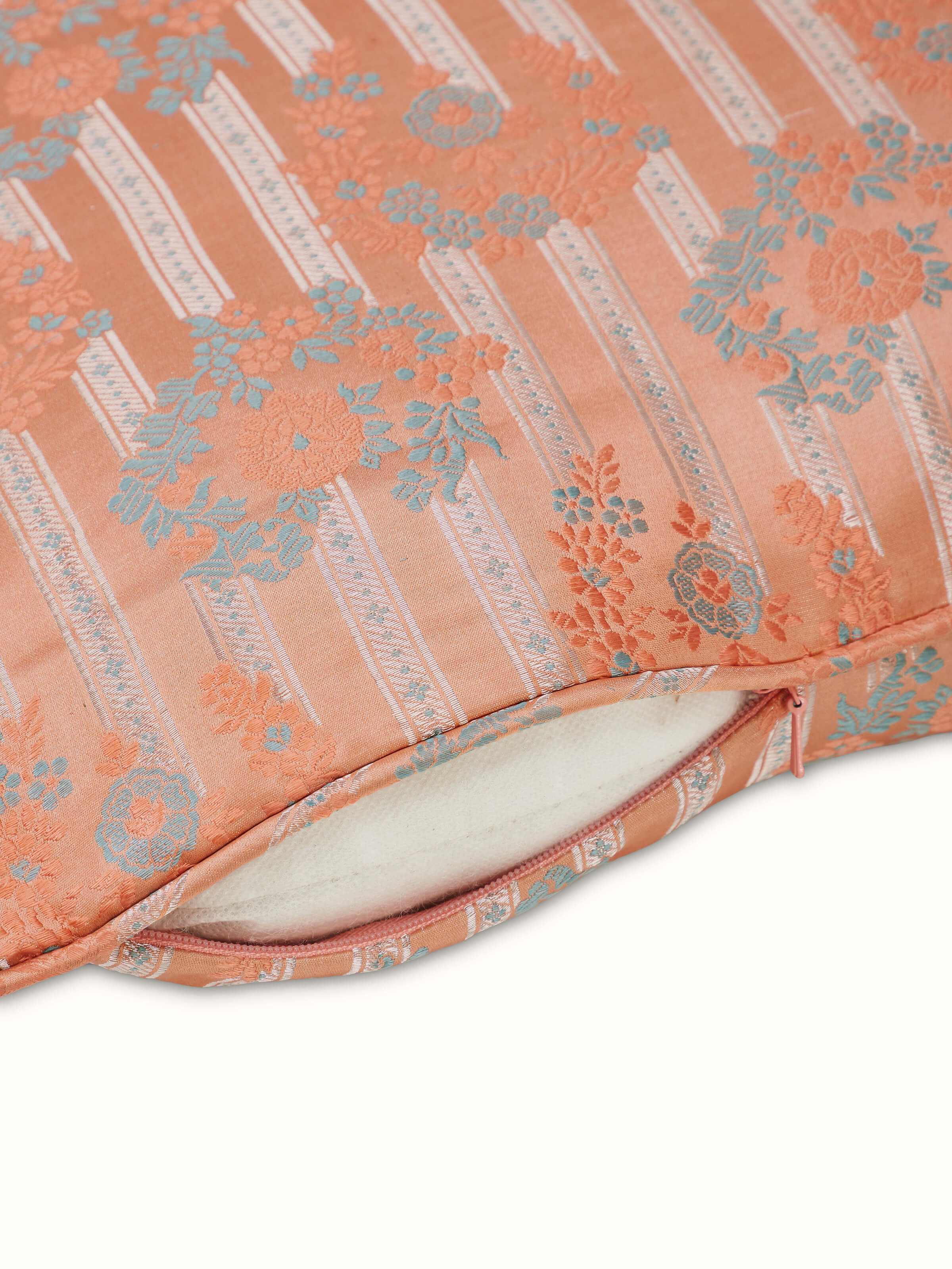 Close-up view of silk brocade cushion cover showcasing fine handloom detailing