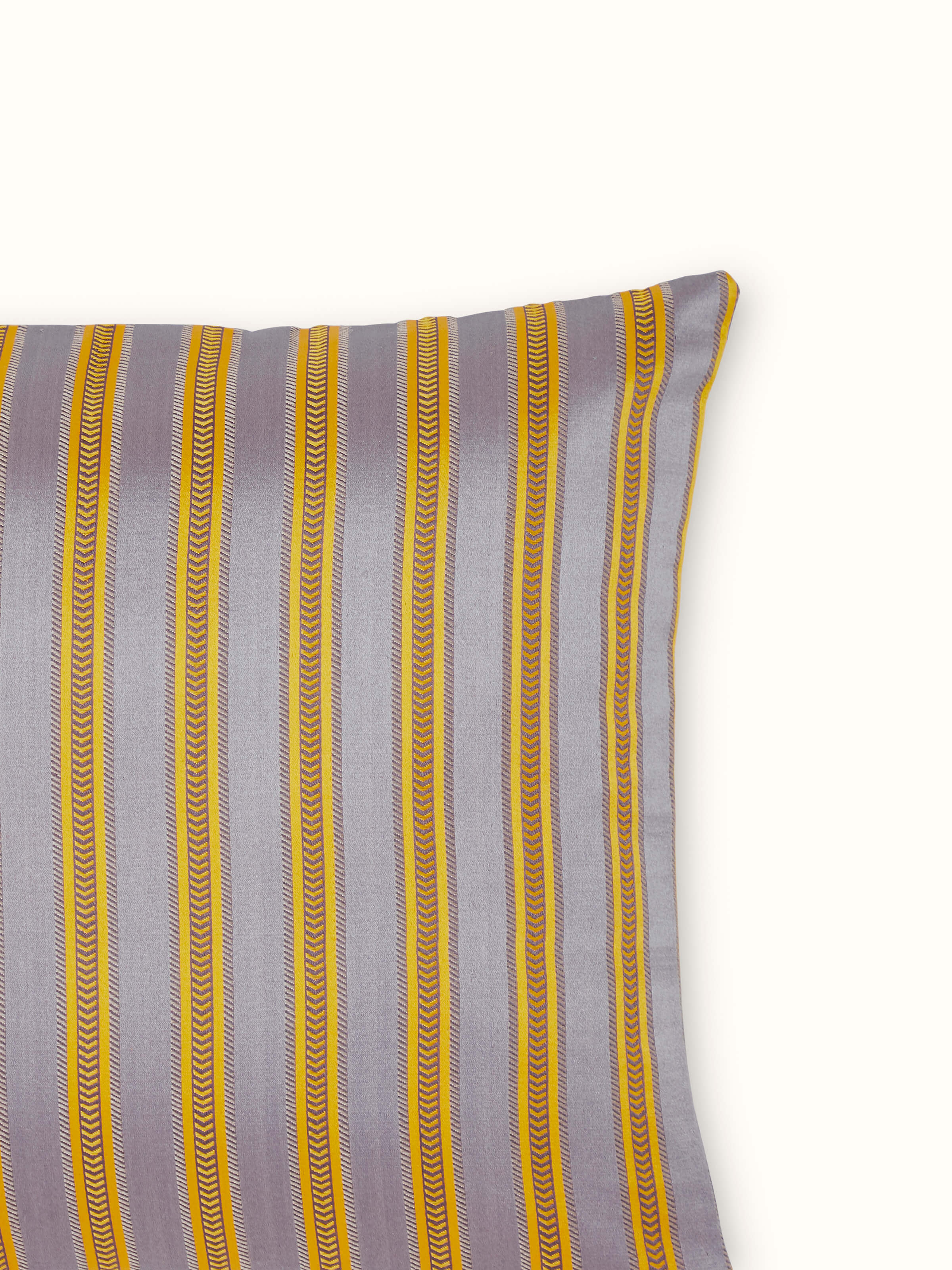Angled view of Aruni grey stripe silk mashru Banarasi handloom cushion cover, showing its full design and texture.