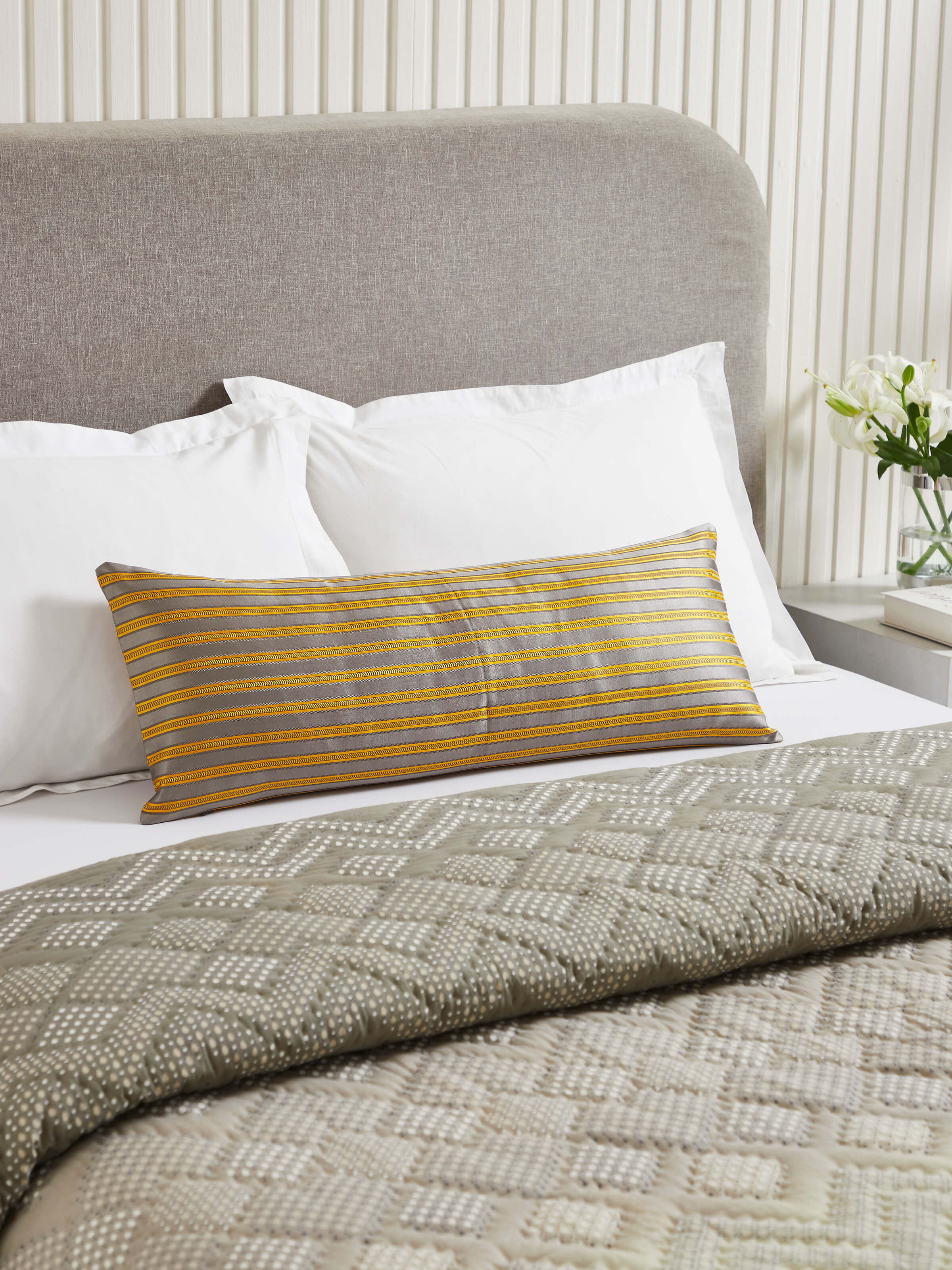 Close-up of Aruni grey stripe silk mashru Banarasi handloom lumbar cushion cover highlighting the intricate silk pattern.