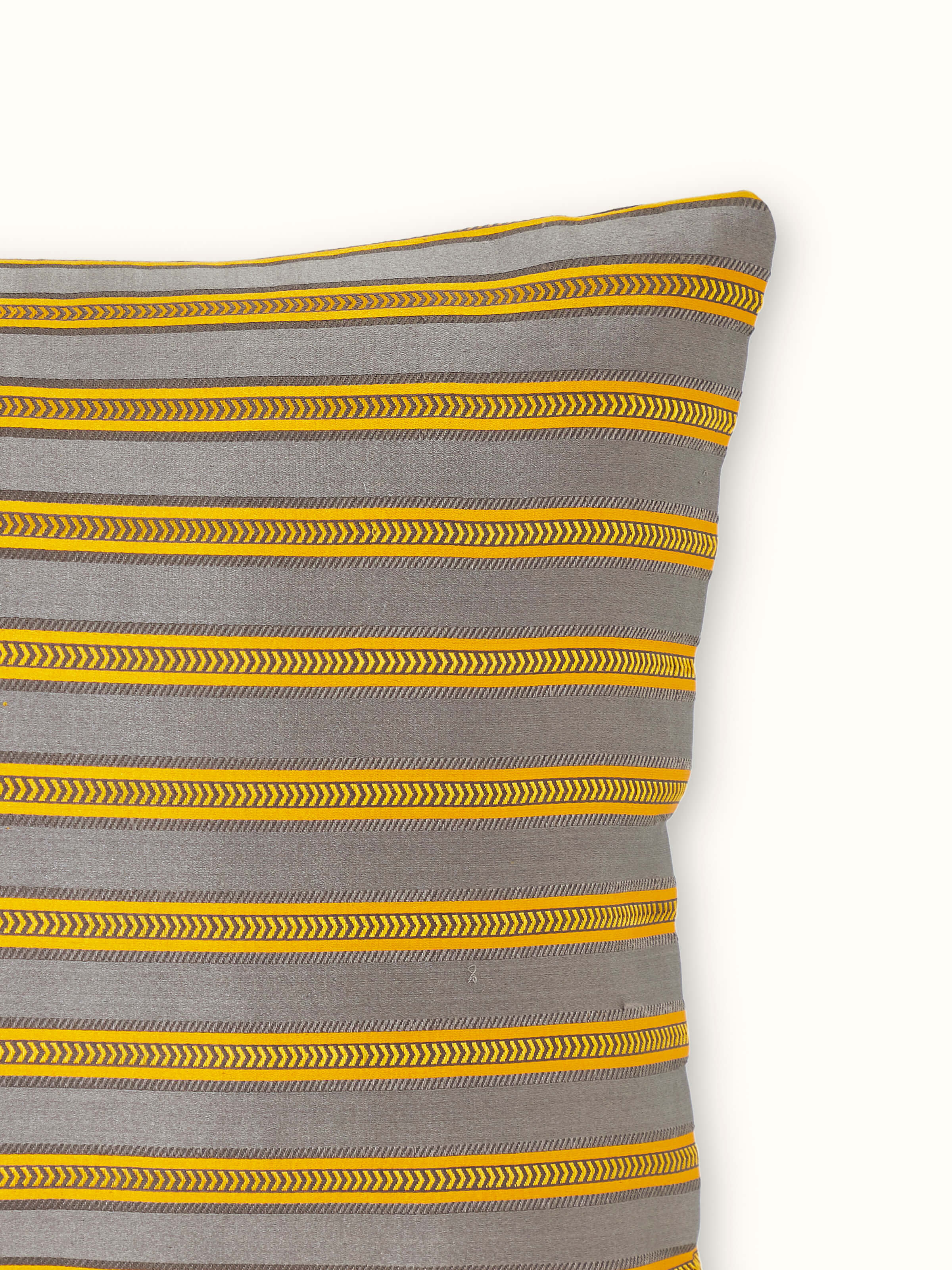 Side view of Aruni grey stripe silk mashru Banarasi handloom lumbar cushion cover showing its color and stripe pattern.