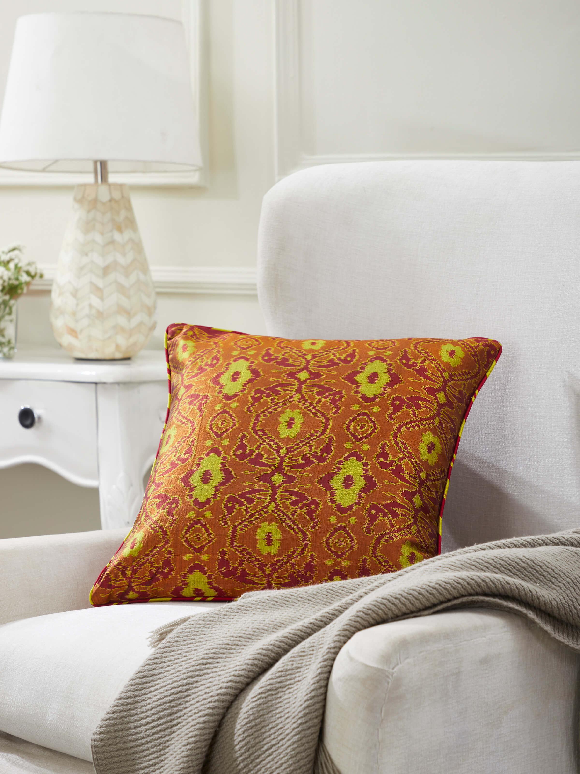 Close-up of Bhoomi red allover silk Odisha handloom ikat cushion cover highlighting the silk texture and ikat pattern details