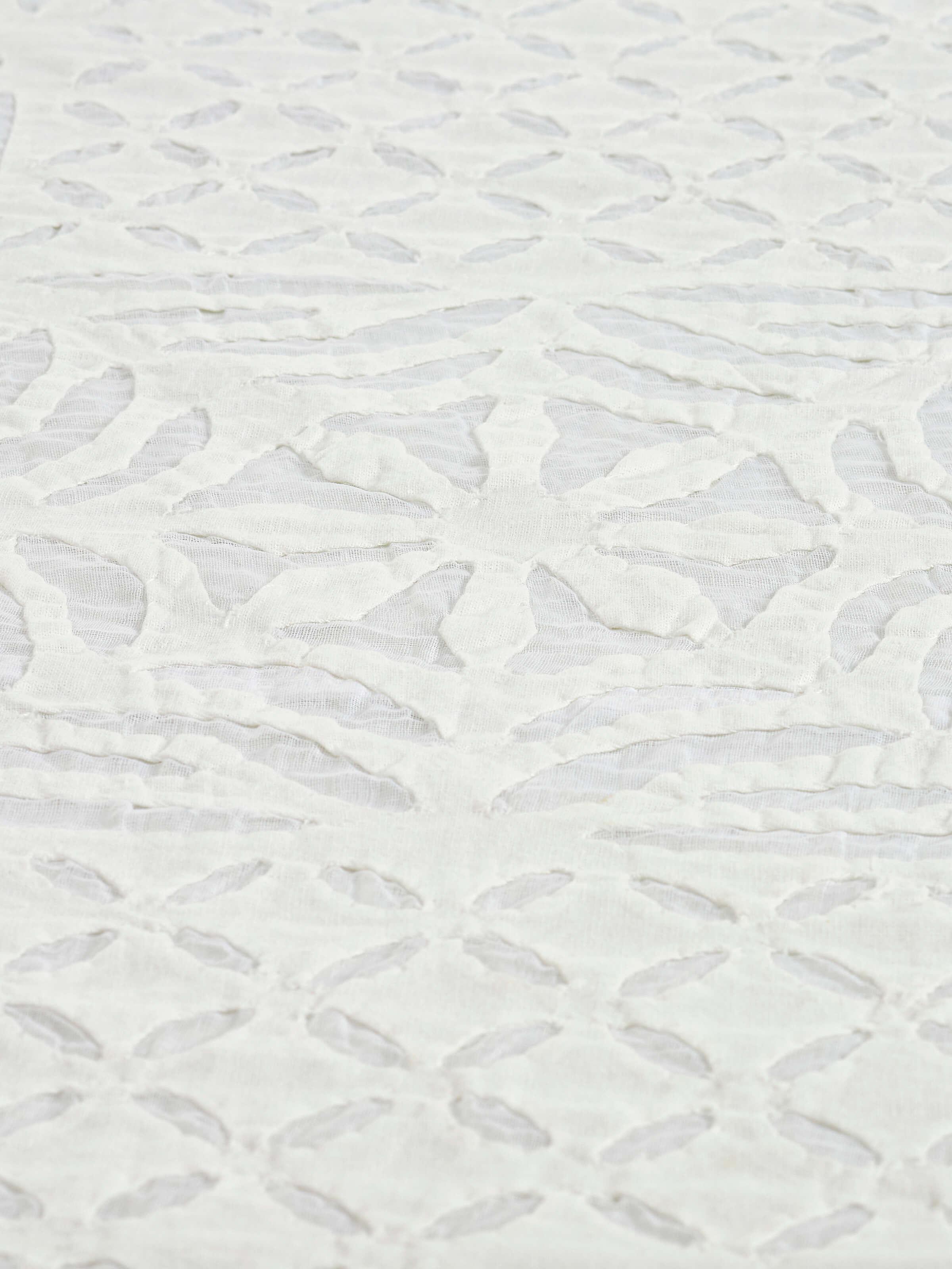 Close-up of Ekam white trellis cotton appliqué embroidered table cover (4 seater) with focus on the detailed appliqué work.