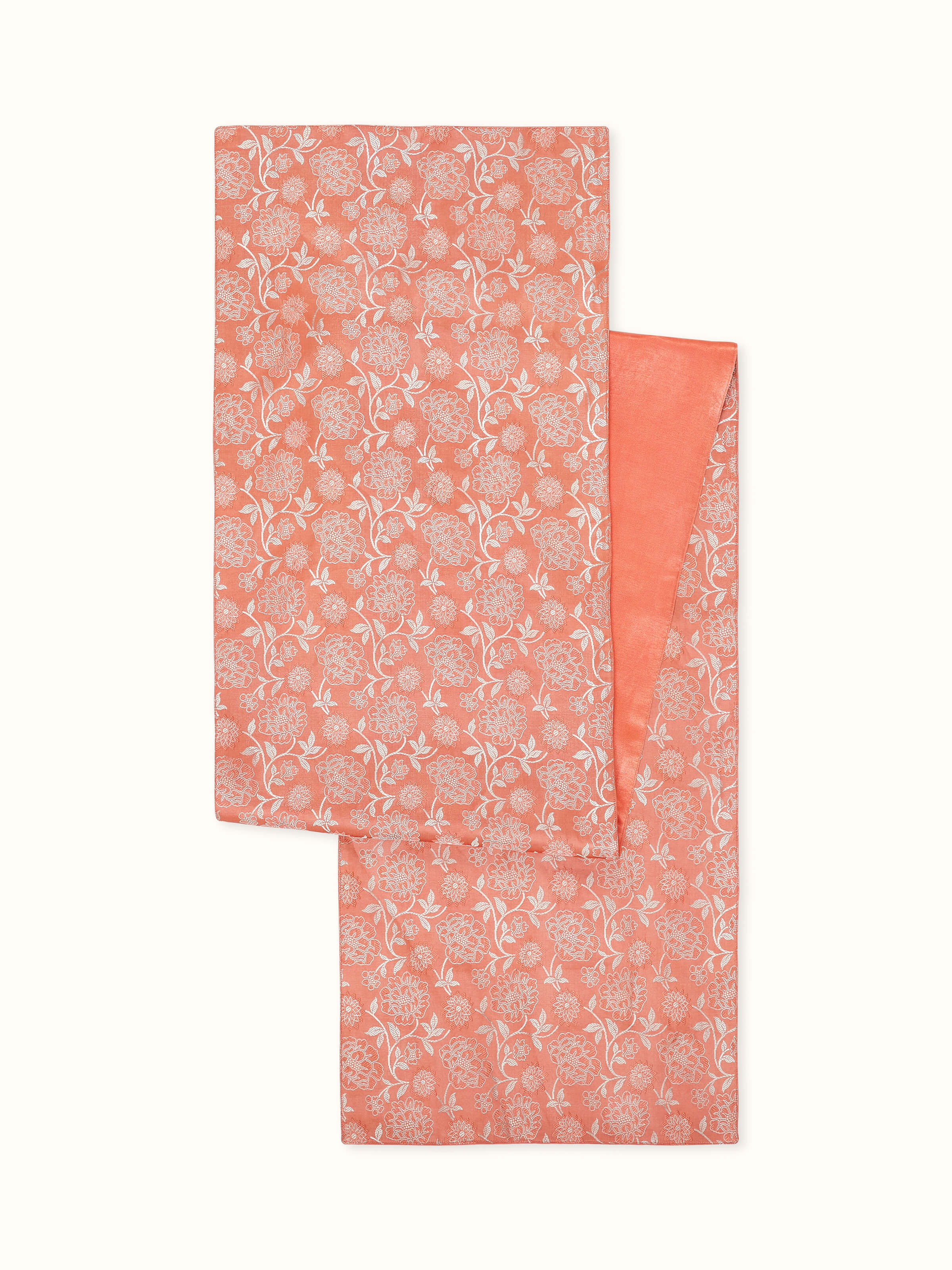 Front view of Ahilya handloom table runner in peach silk with intricate Banarasi jaal brocade work.