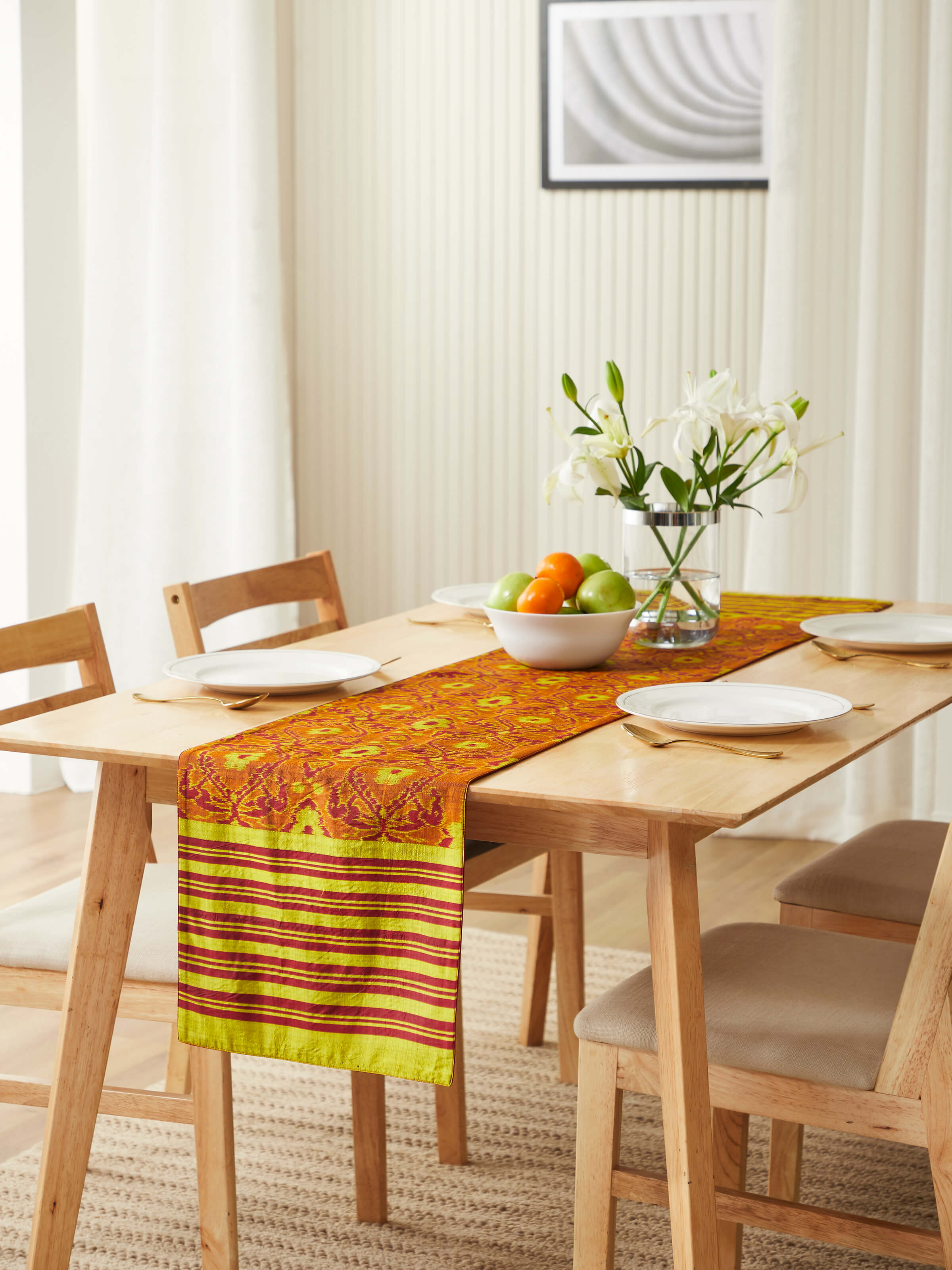 Lifestyle setting of Bhoomi red Ikat runner adding vibrant charm to a dining table