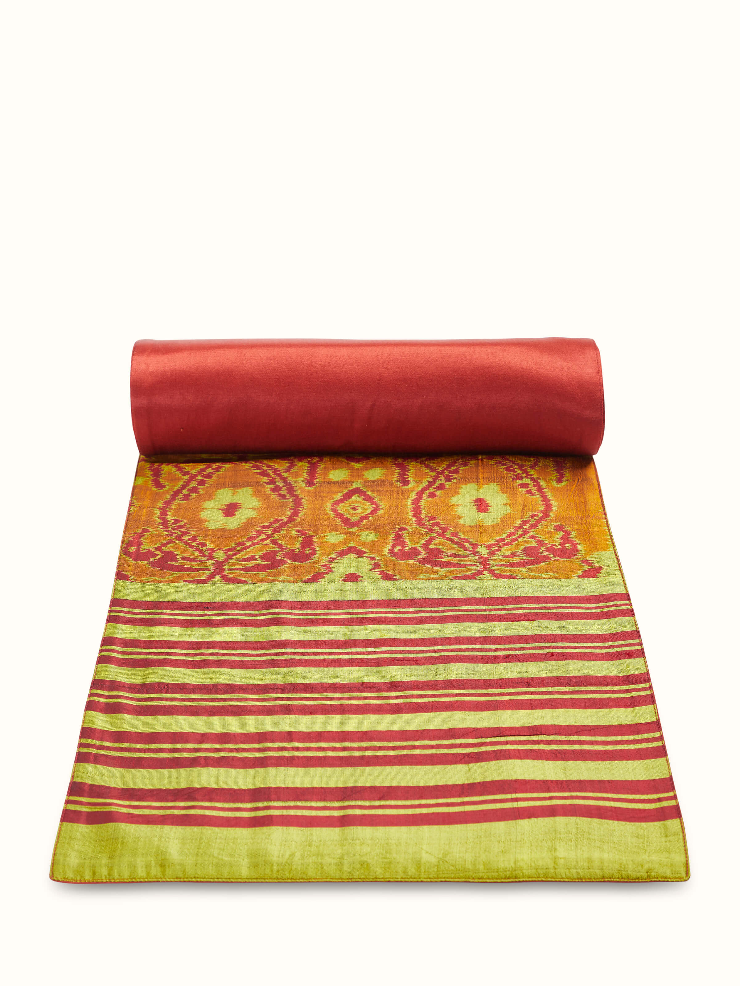 Close-up of handwoven Ikat patterns with precise red stripe alignment in silk texture