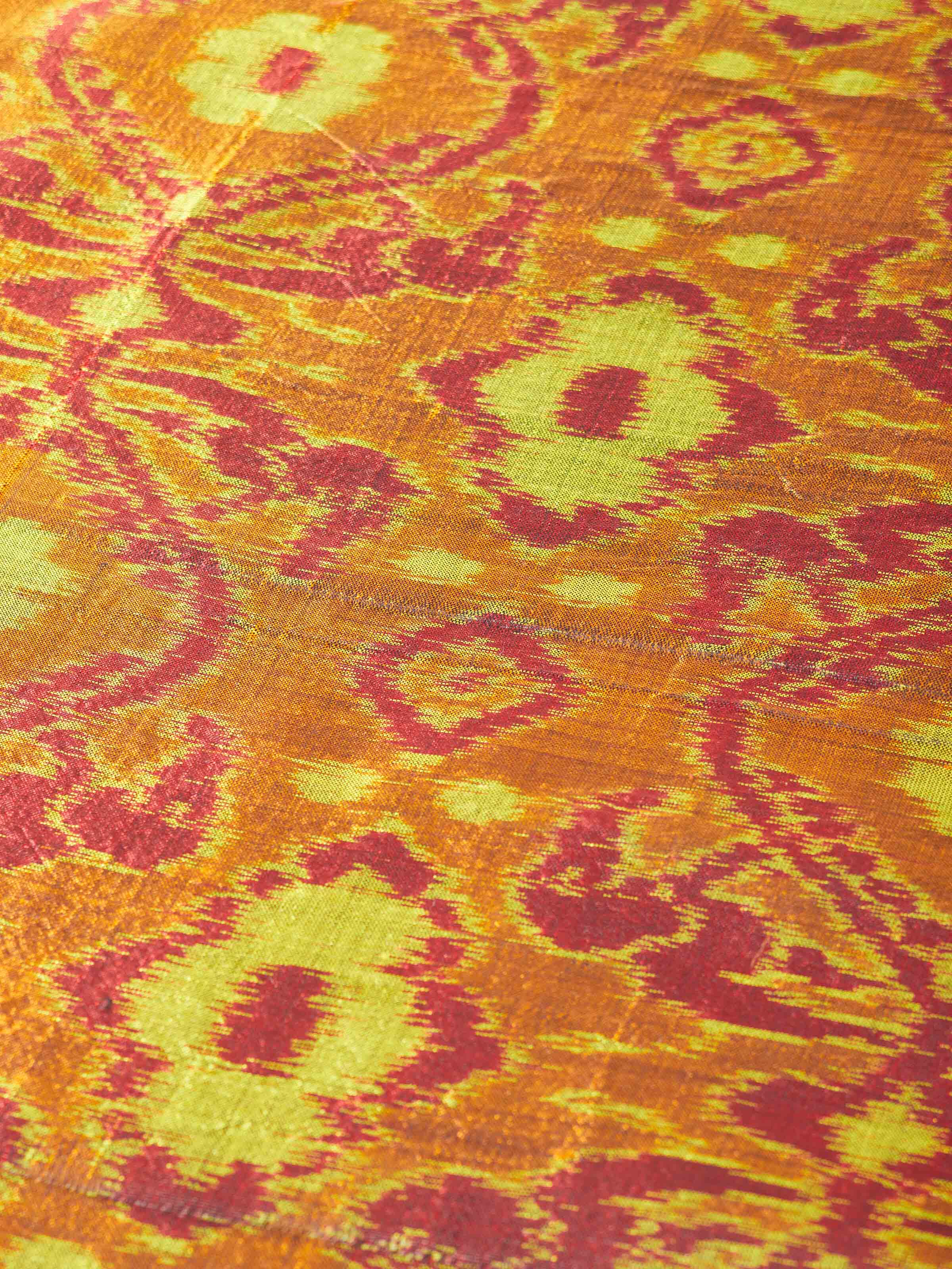 Textural close-up highlighting vibrant red tones and fine Odisha handloom artistry