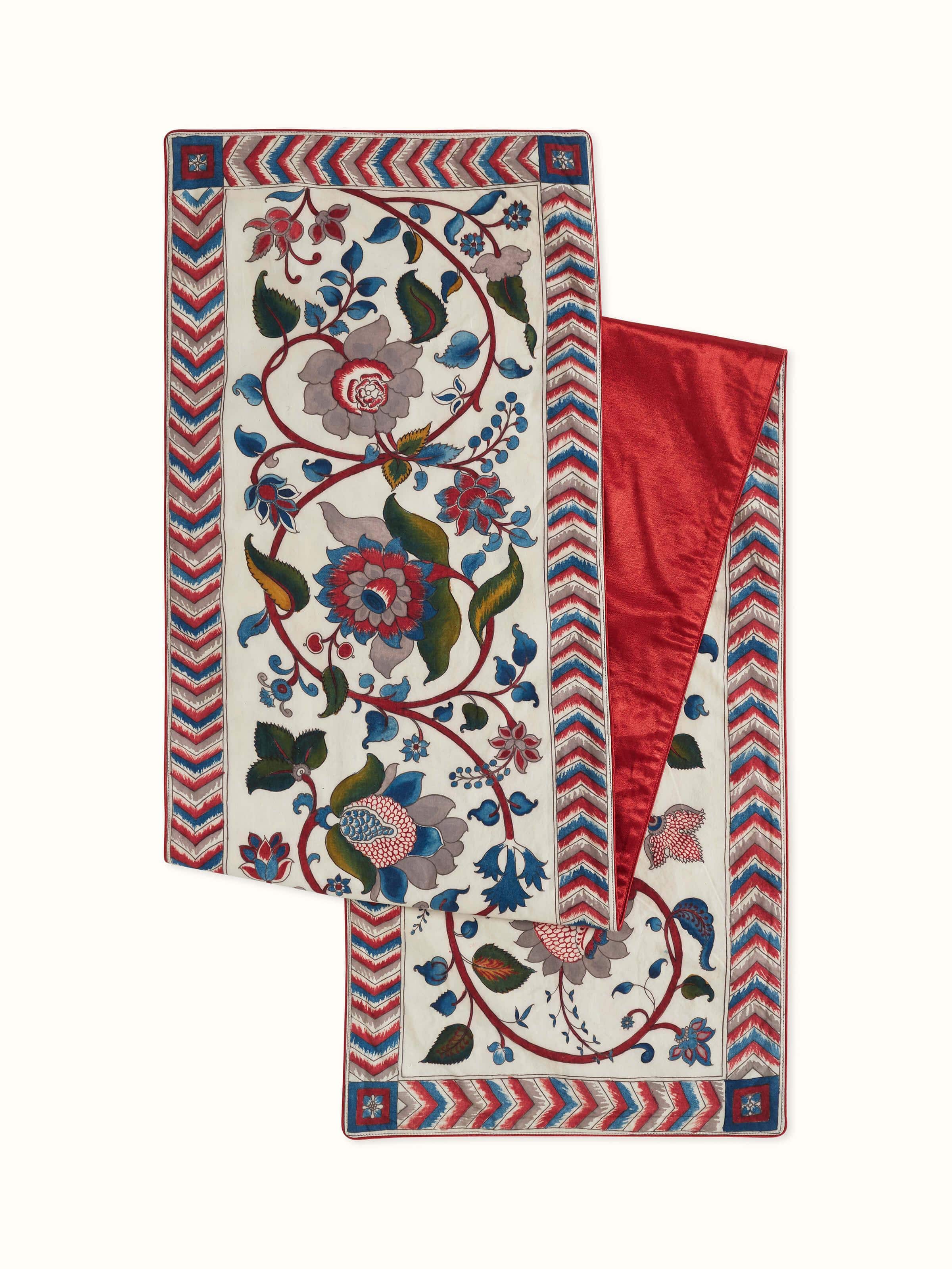 Front view of red cotton Kalamkari table runner with hand-painted floral motifs.