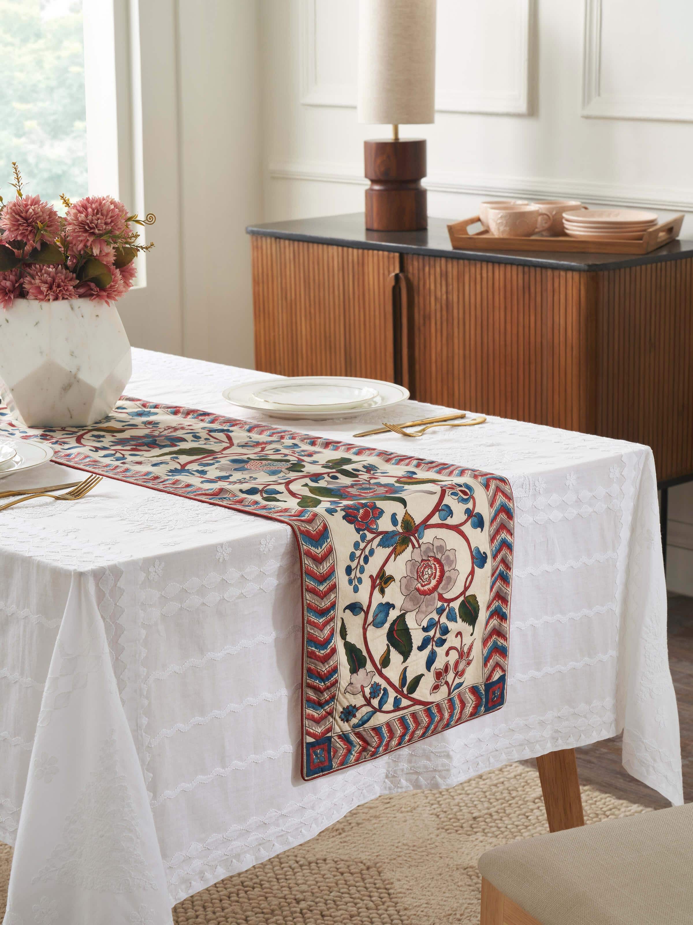 Lifestyle setting of red table runner enhancing traditional table décor.