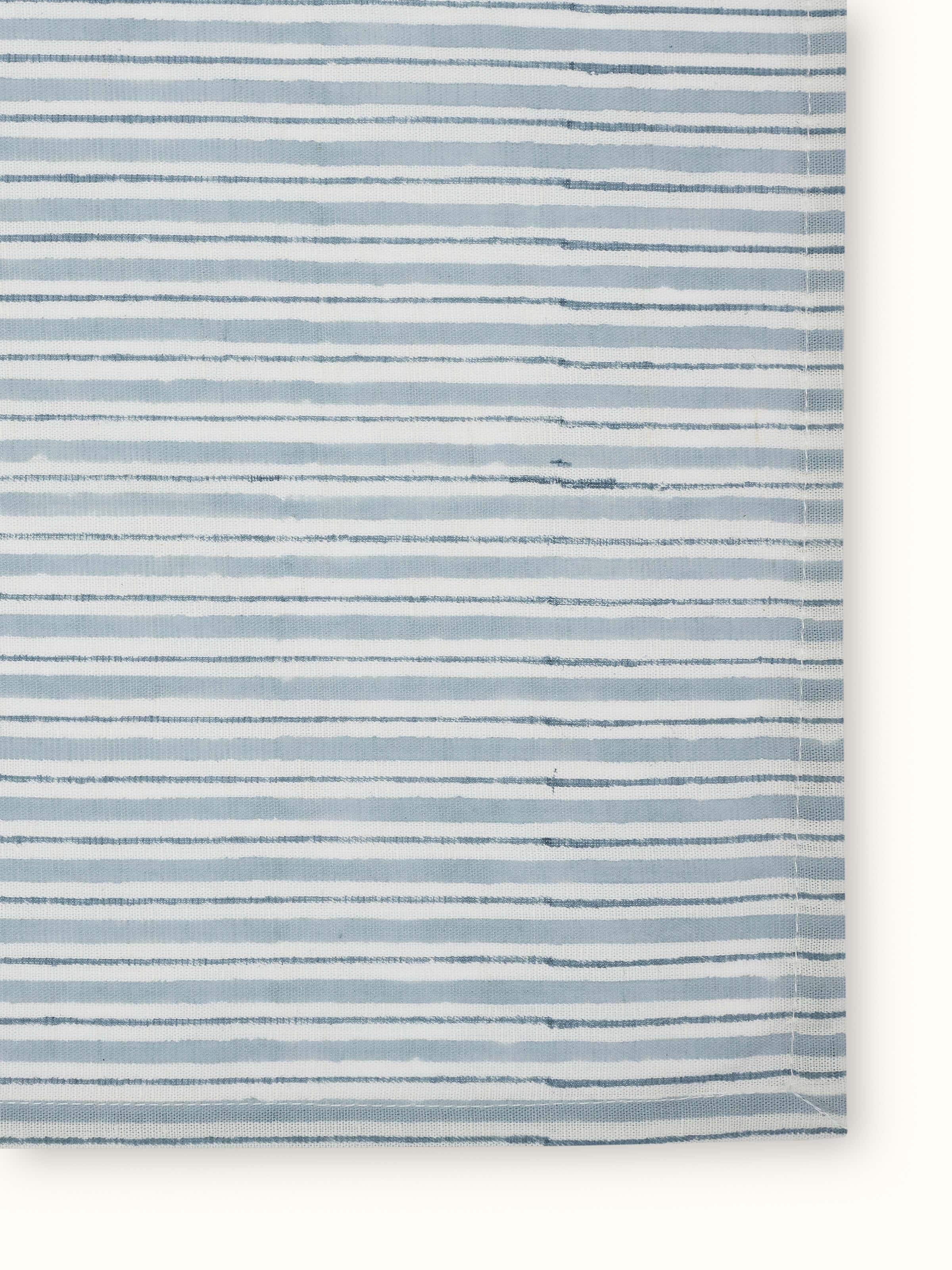 Angled view of Anika Light Blue Stripe Cotton Linen Sanganeri Block Printed Dinner Napkins highlighting the texture and color contrast of the fabric.