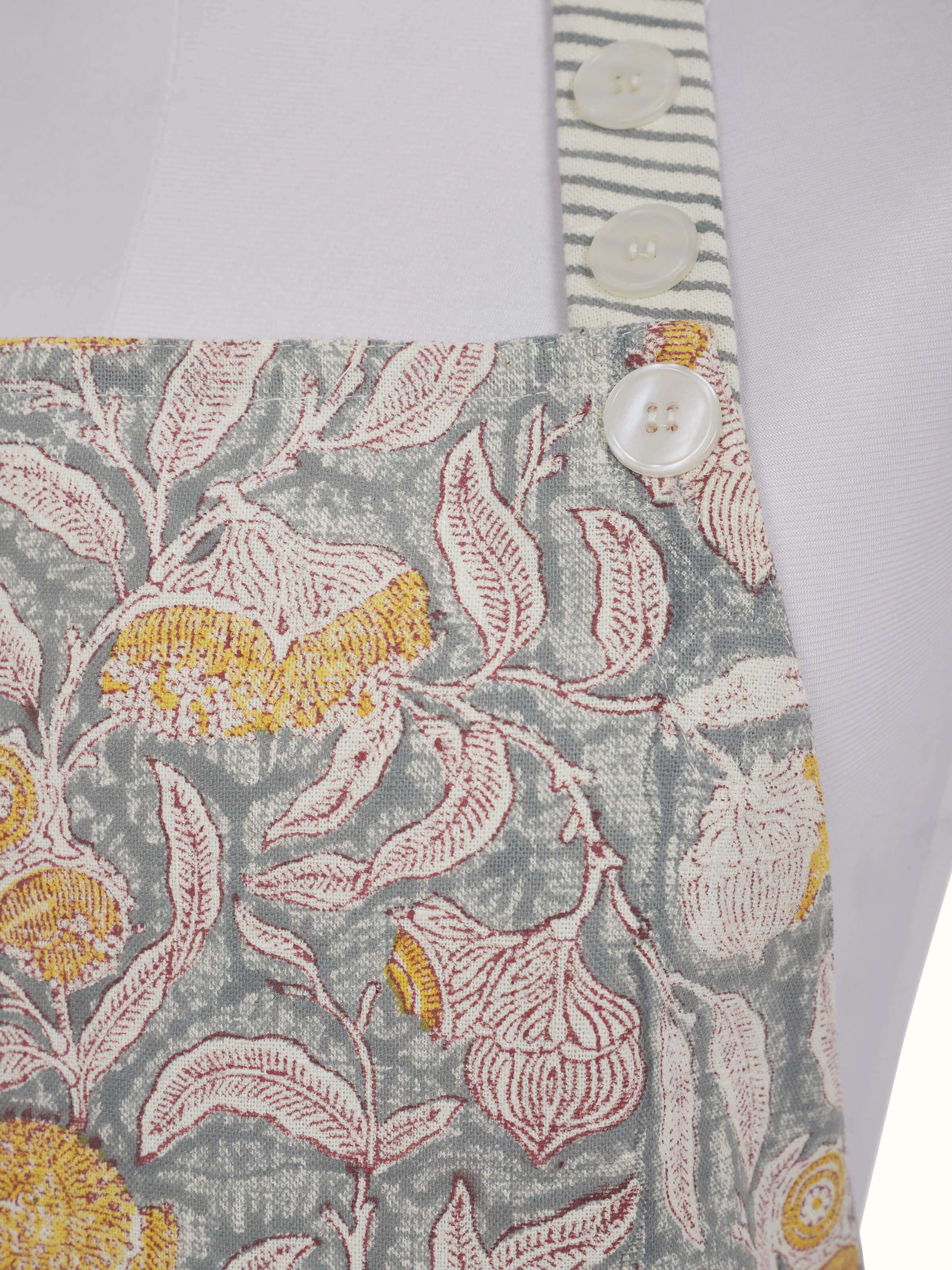 Close-up view of grey floral cotton Sanganeri block printed apron highlighting the fabric texture and print details.