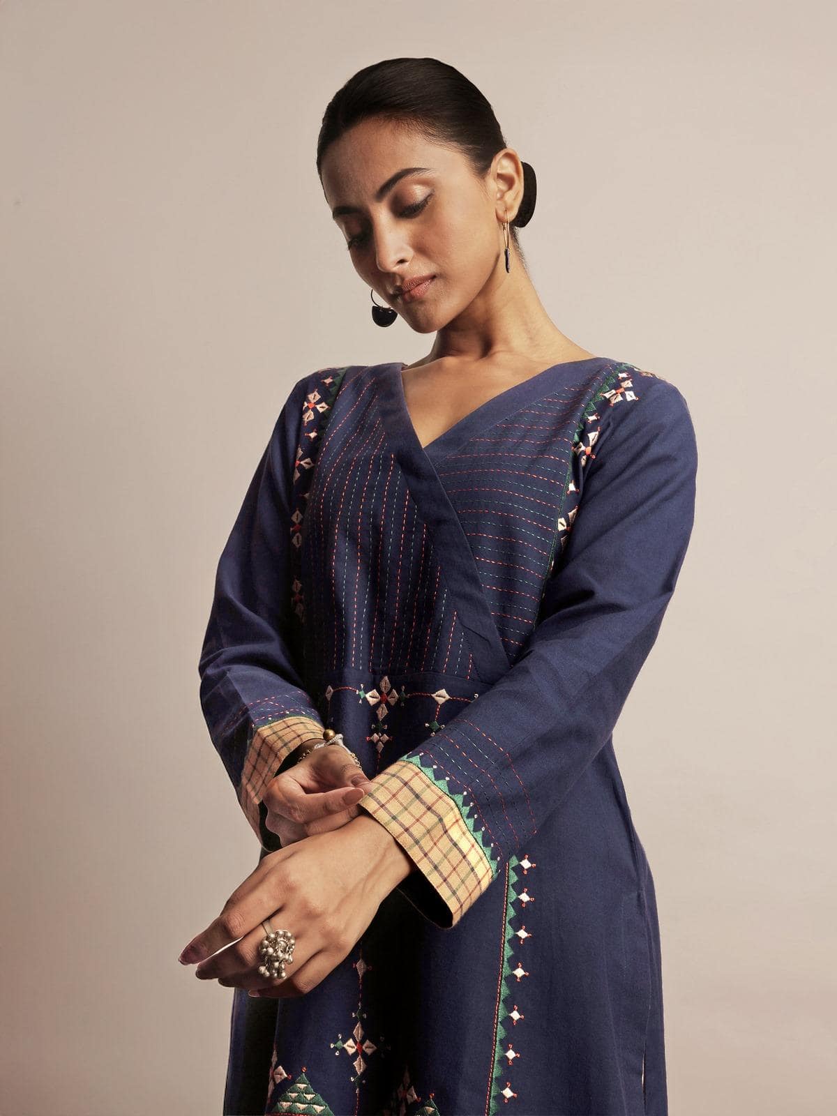 Full-length lifestyle shot of blue cotton kurta styled with matching accessories.