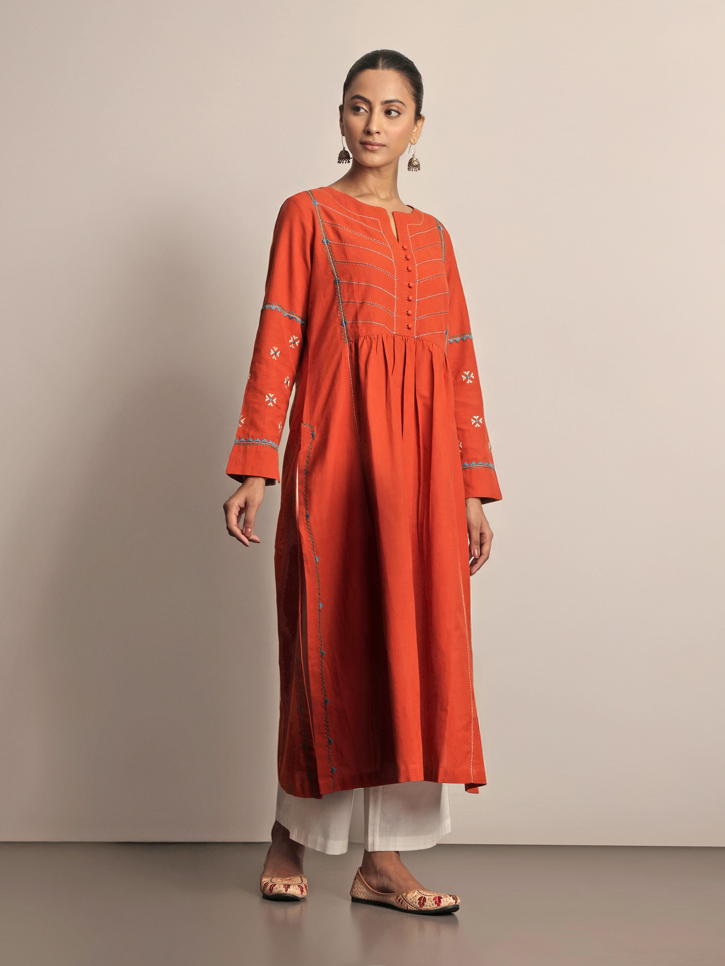Lifestyle view of Rust Cotton Rajasthani Embroidered Kurta worn casually, showcasing embroidery details and comfortable fit.