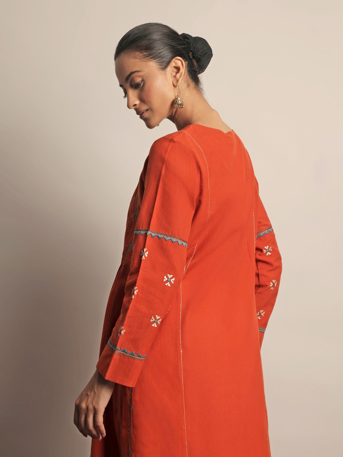 Angled view of Rust Cotton Rajasthani Embroidered Kurta highlighting intricate threadwork on soft cotton fabric.