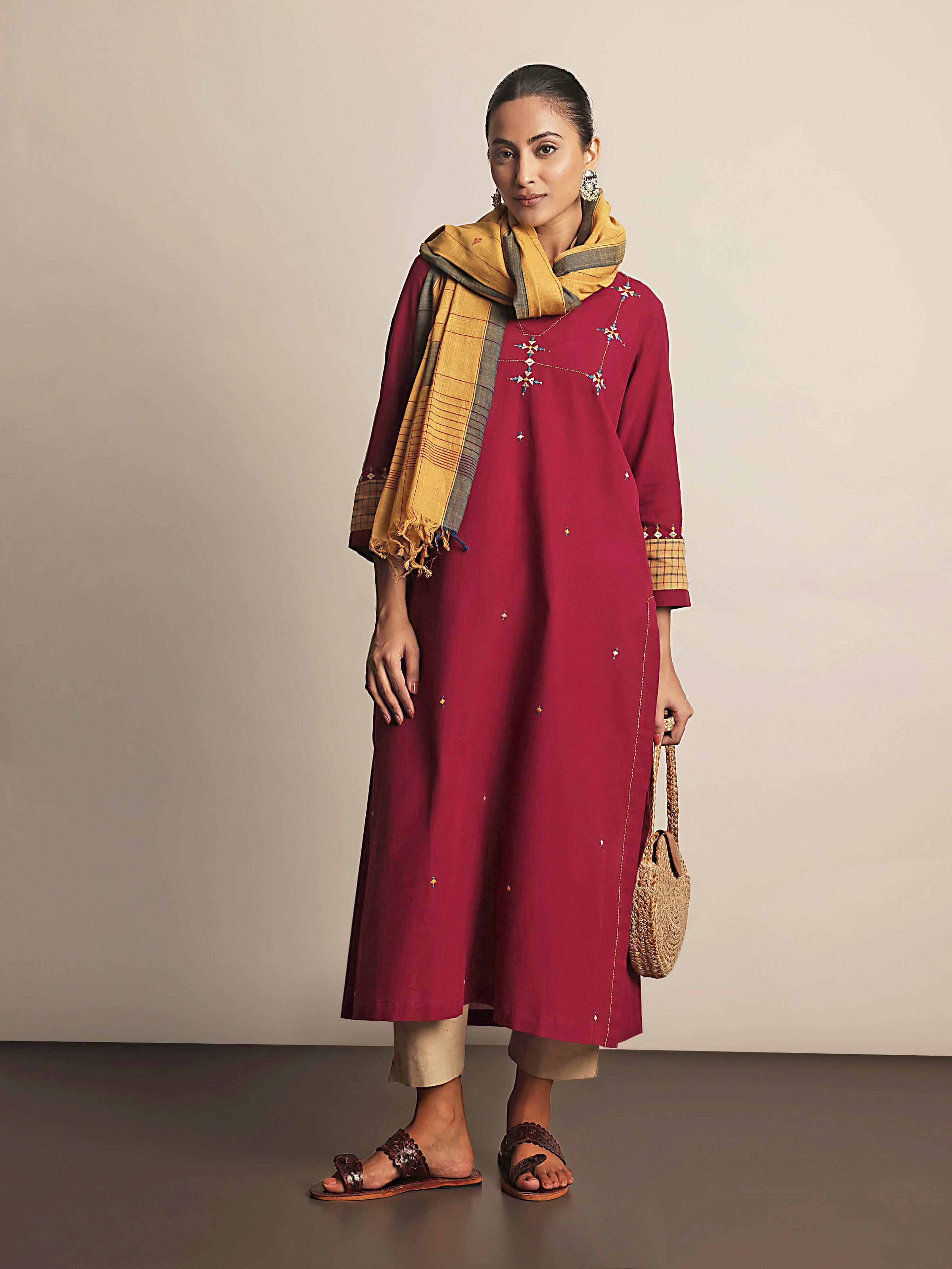 Lifestyle shot of maroon cotton Rajasthani kurta styled casually with embroidery focus.