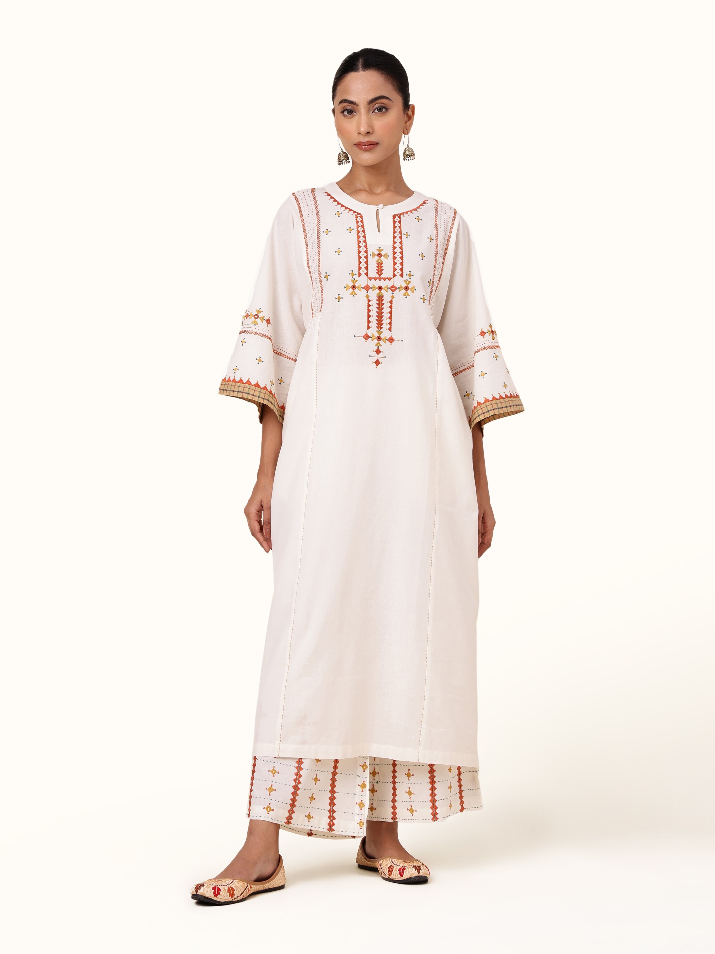 Front view of off-white cotton kurta featuring intricate Rajasthani embroidery on the neckline and chest area.