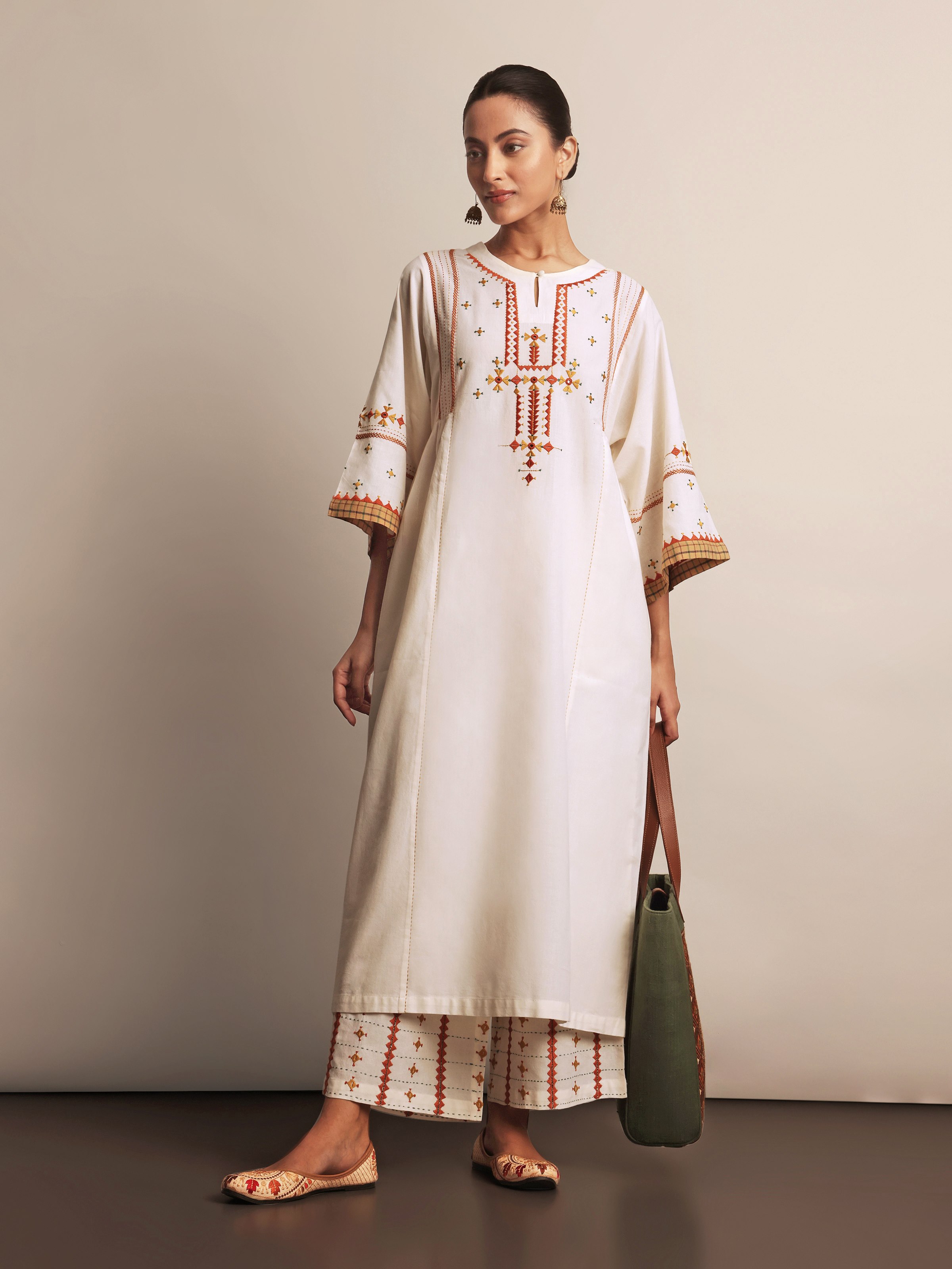 Model wearing off-white Rajasthani embroidered kurta styled with full sleeves and straight fit.