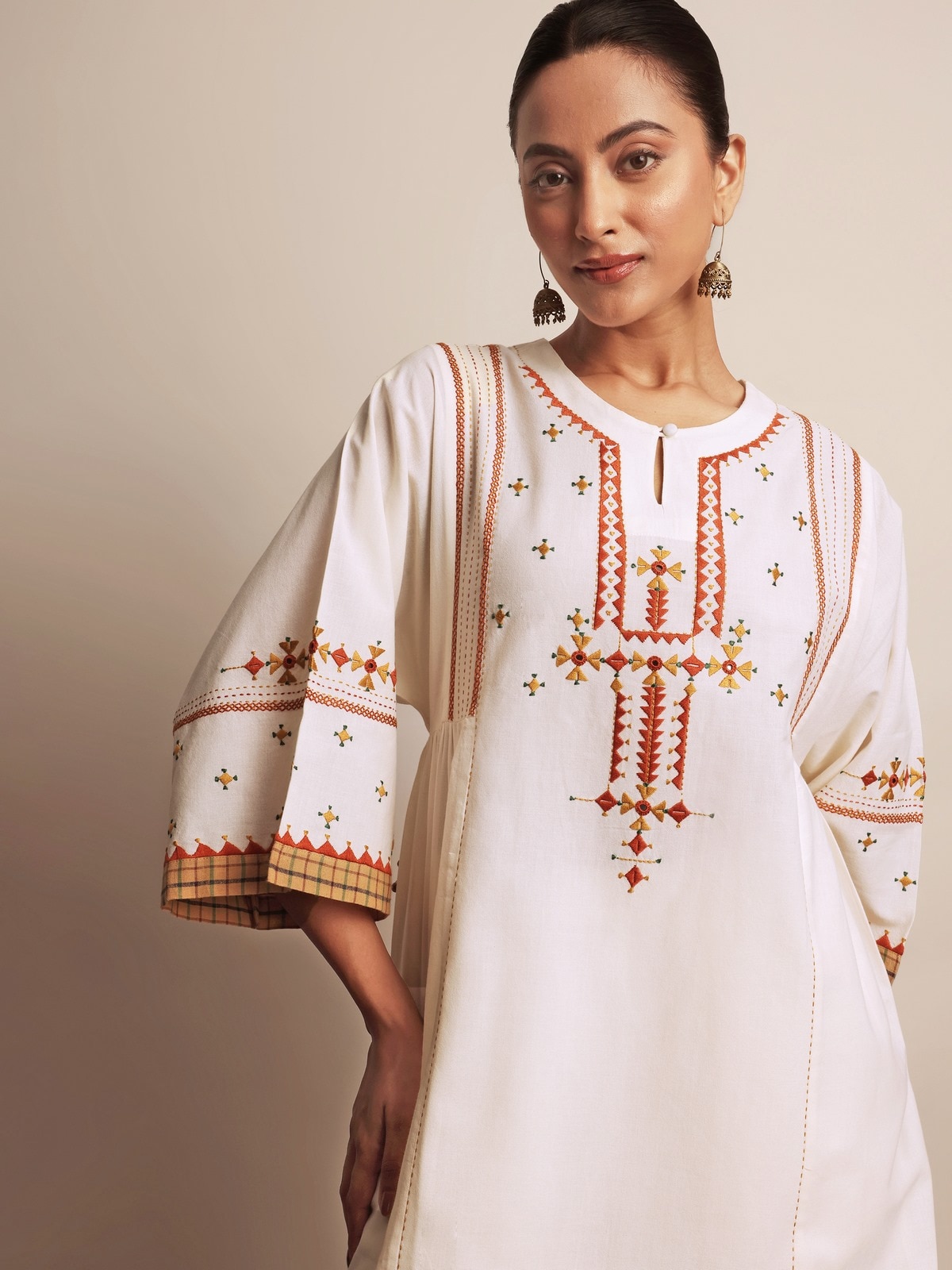 Close-up of sleeve and embroidery design on off-white Rajasthani cotton kurta.