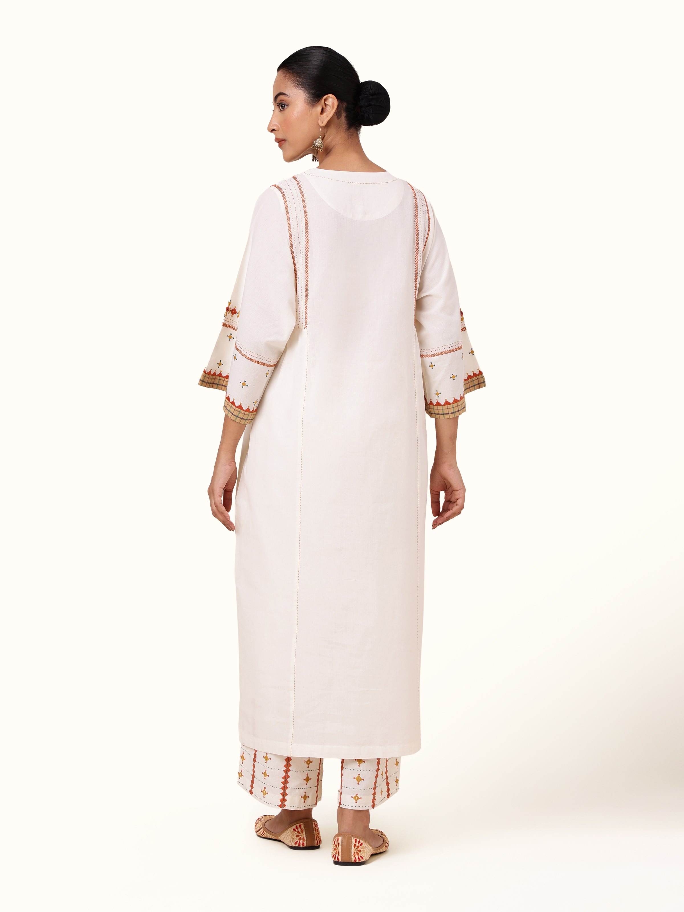 Back view of off-white cotton kurta with subtle embroidery on the upper back and clean silhouette.