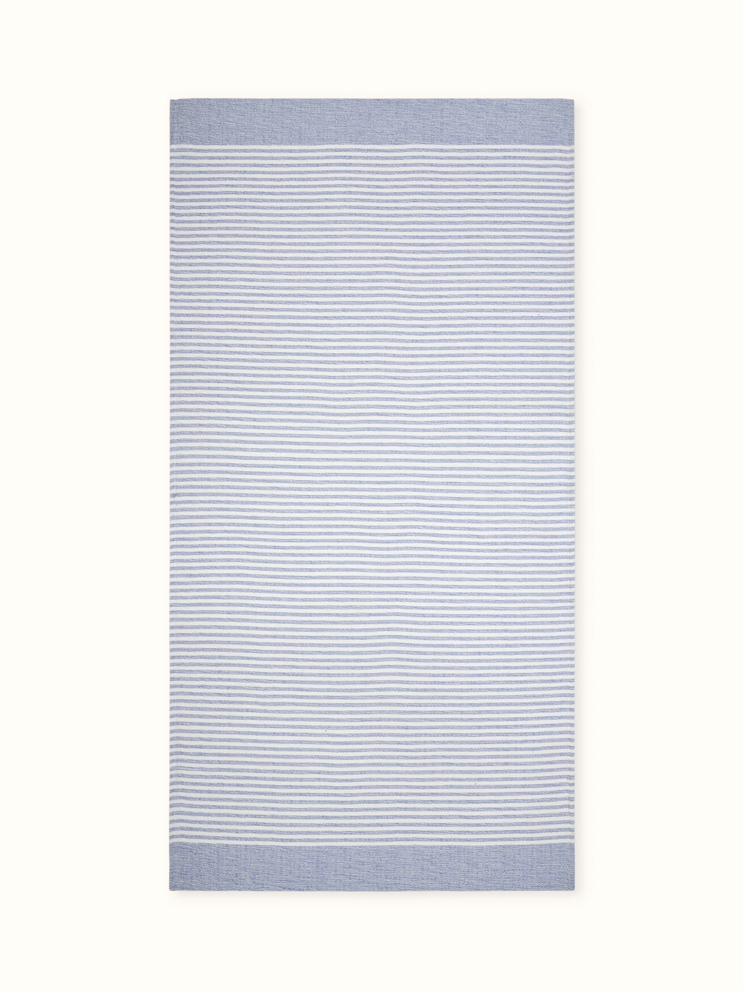 Full view of Vayana stripe blue cotton bath towel (L) displaying the blue stripes and soft cotton texture.