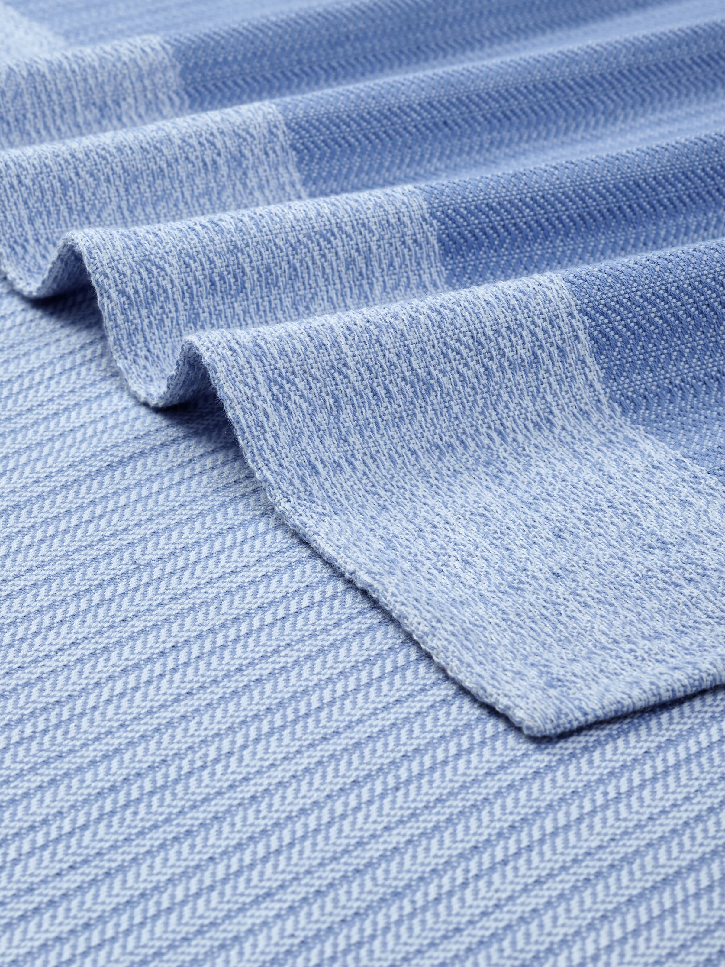 Vayana solid blue stripe cotton bath towel (XL), folded to show its compact size and durable fabric.