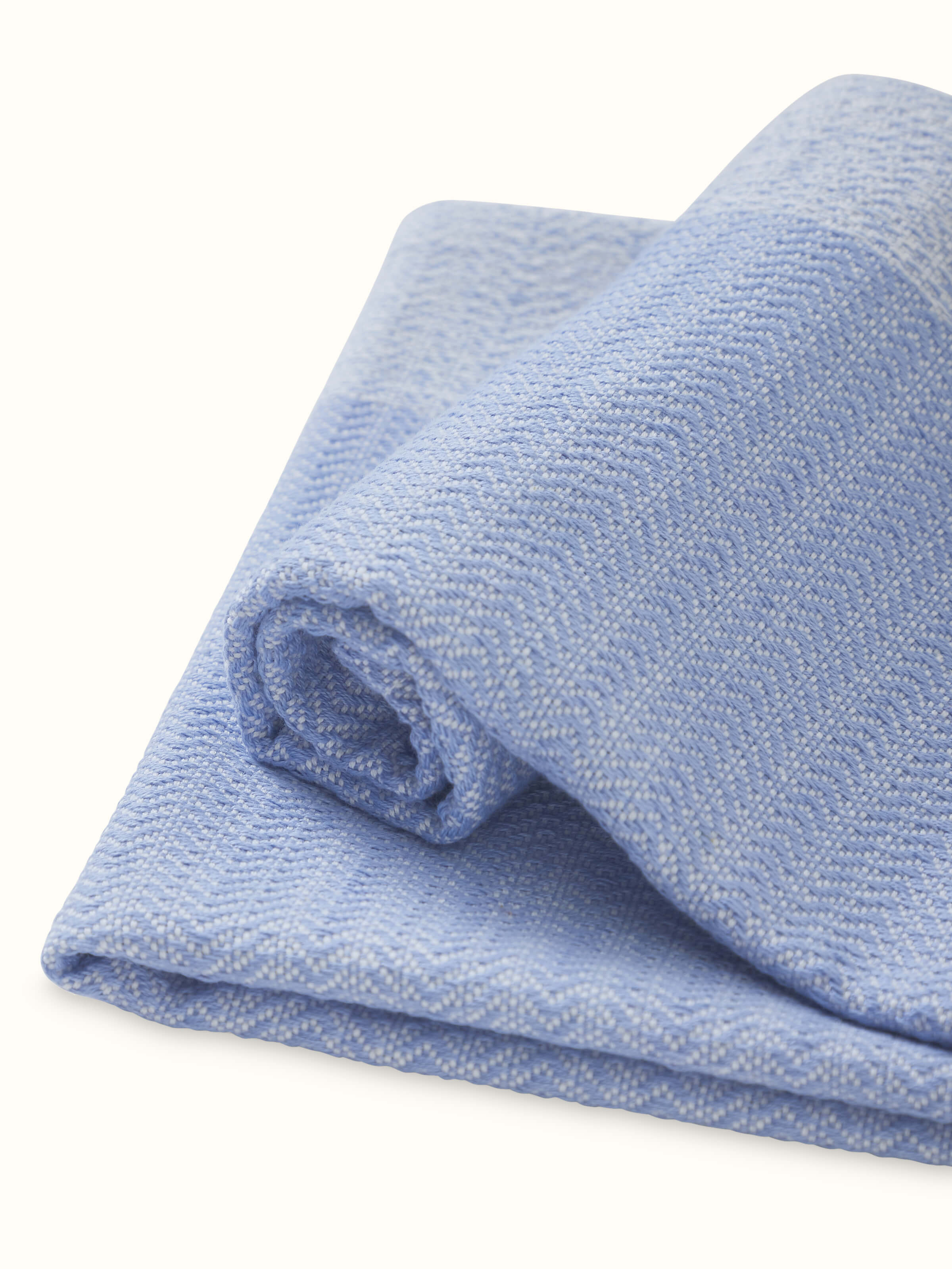 Perspective view of Vayana solid blue stripe cotton hand towels (2 pcs) demonstrating the blue stripe design and hand towel size.
