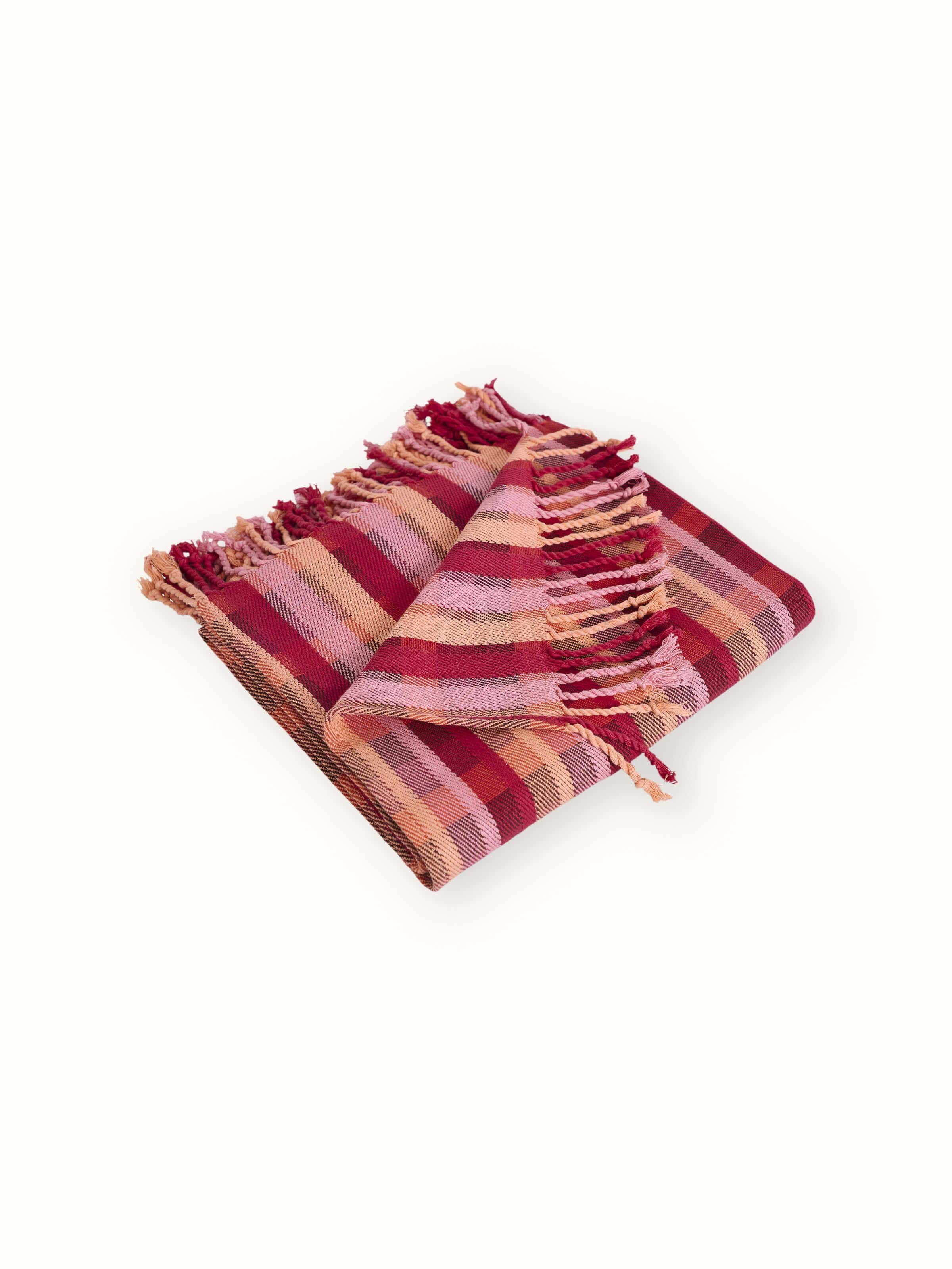 Back view of Niketa Raspberry Plaid Throw, showcasing the reverse side’s weave consistency and natural cotton texture.