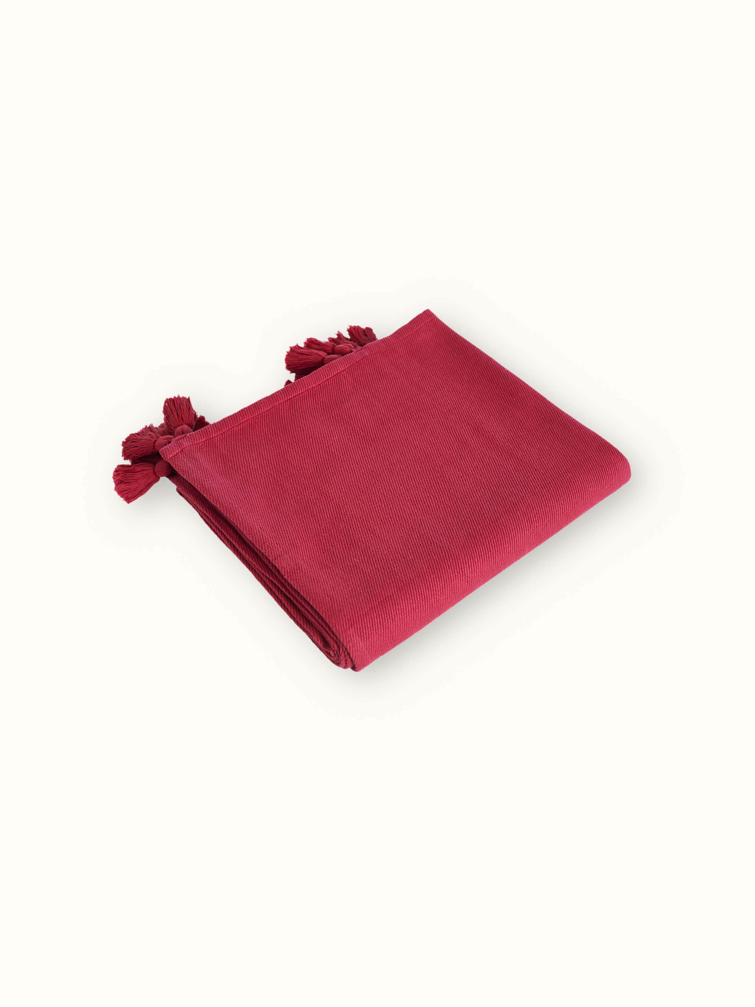 Side view of Tavas Magenta twill cotton throw displaying the fabric's handloom details