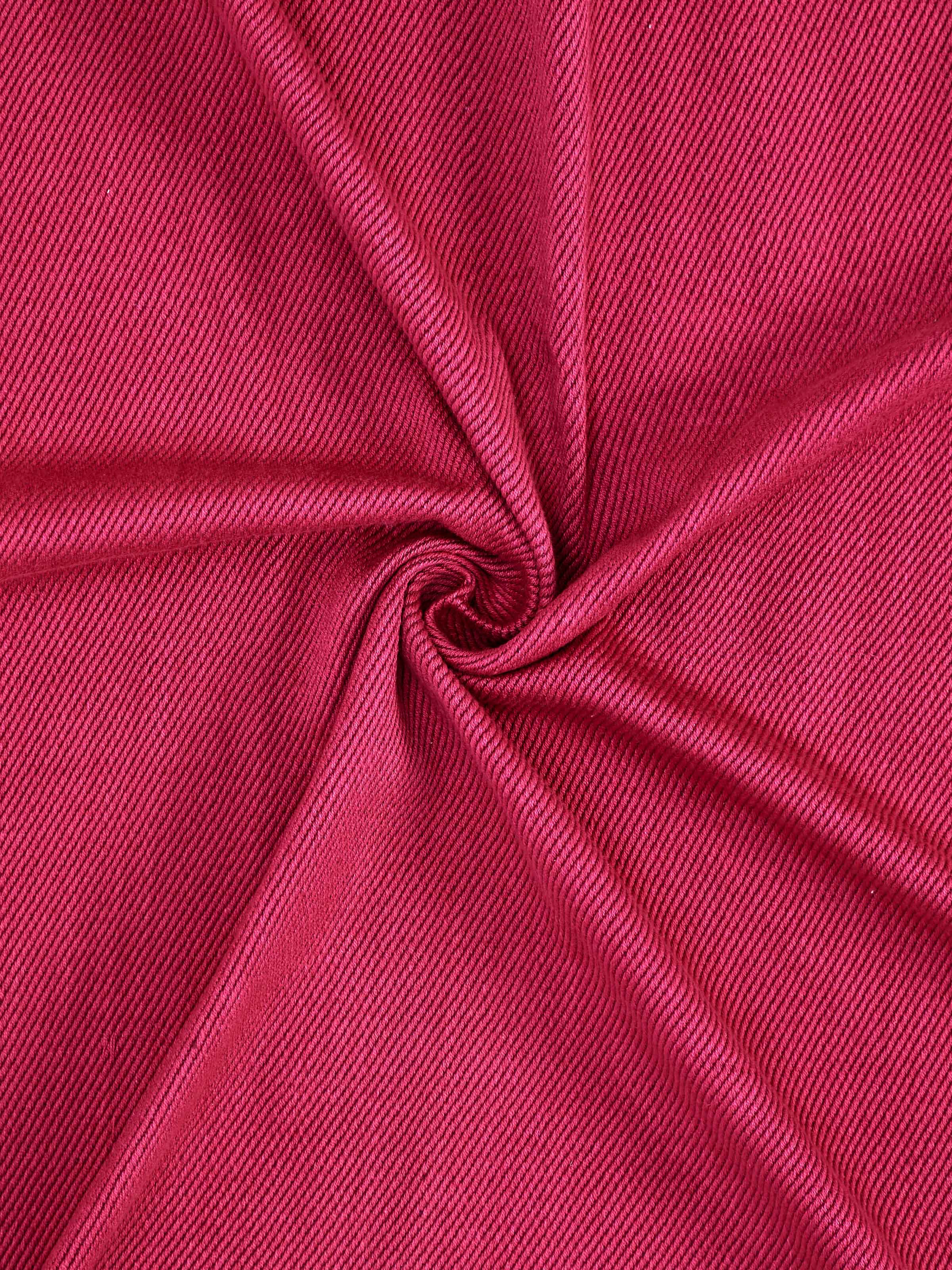 Folded Tavas Magenta cotton handloom throw showing the handwoven pattern and color