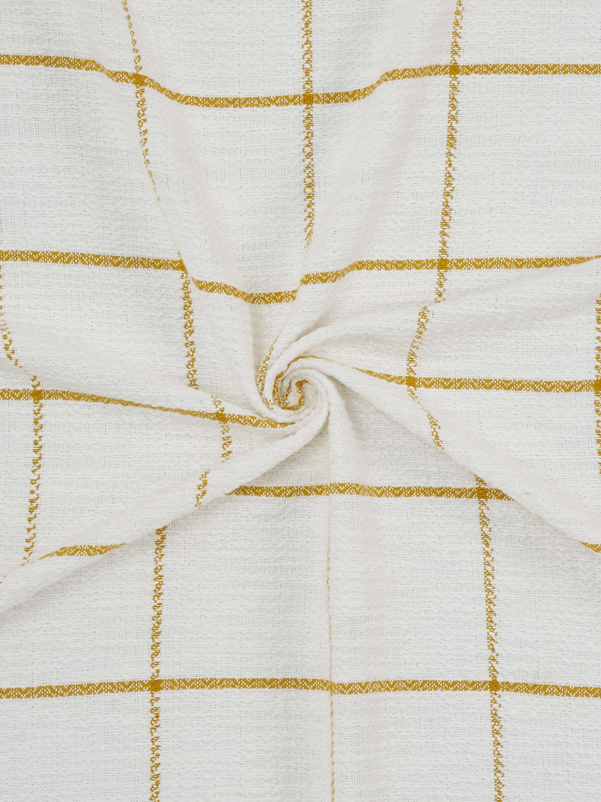 Angled view of Adhima Cotton Throw in ochre, showing layered texture and artisan weave.