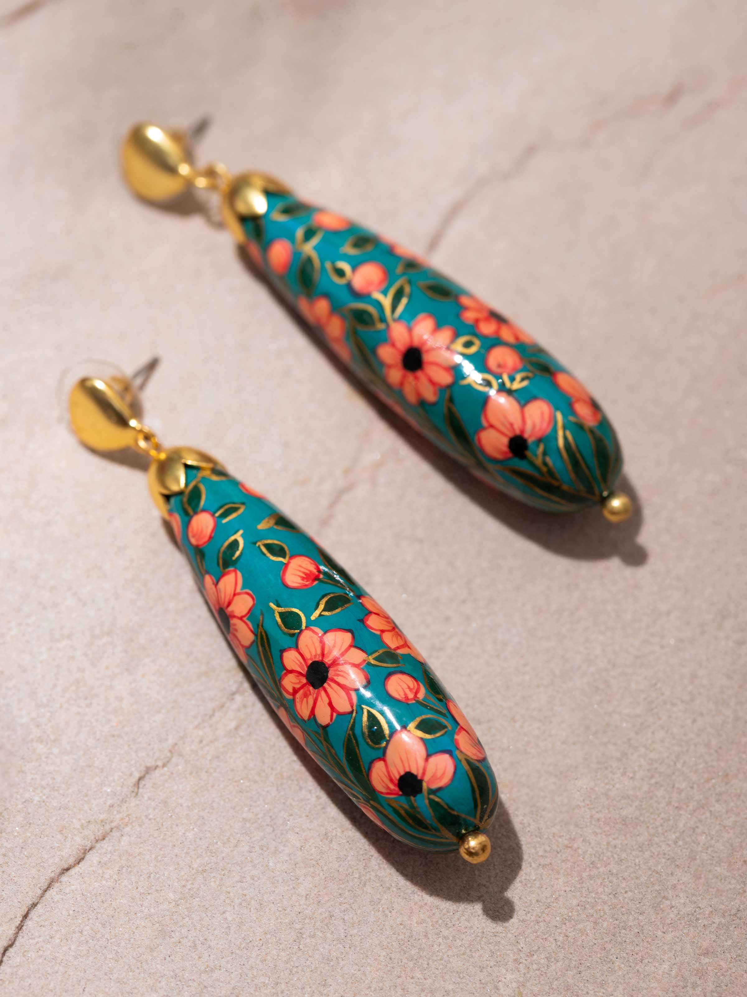Overhead view of papier-mâché drop earrings showing their overall design and hanging style.