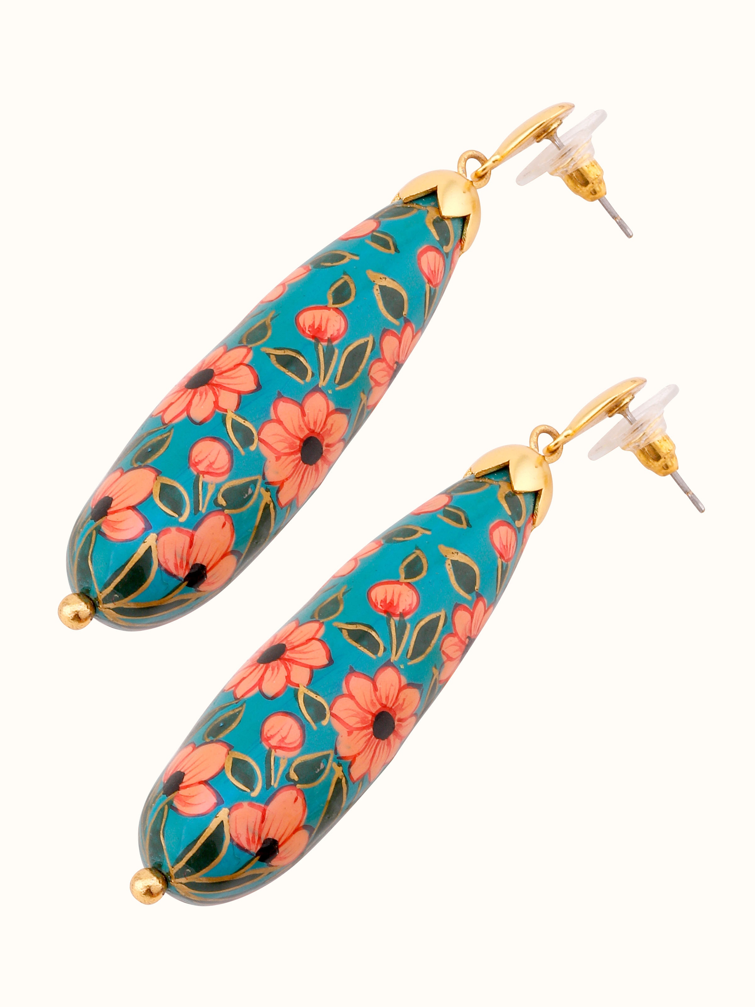 Detailed close-up of papier-mâché drop earrings focusing on the artistic details and texture.