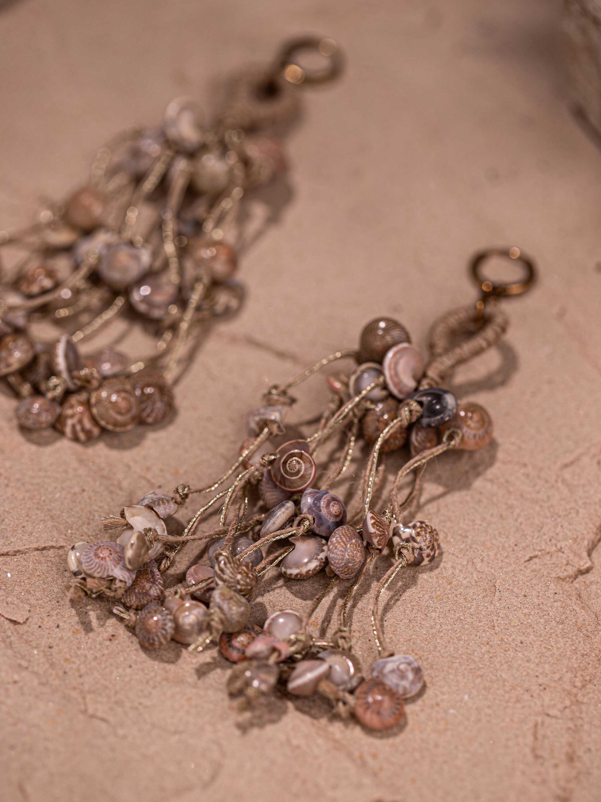 Detailed image of Cowrie Shell Drop Earrings focusing on the unique shell patterns and craftsmanship.