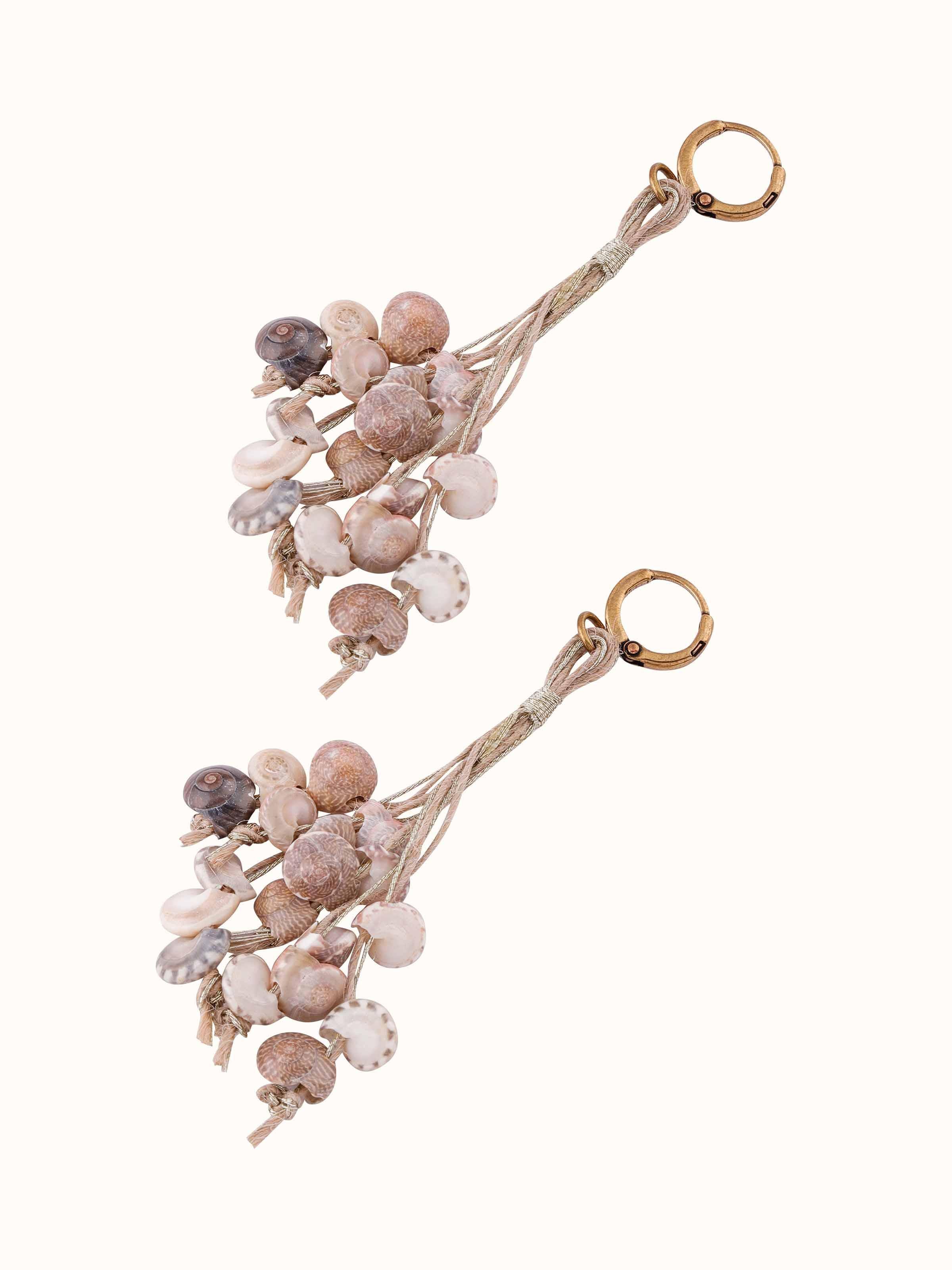 Side view of Cowrie Shell Drop Earrings illustrating the natural shell and design.