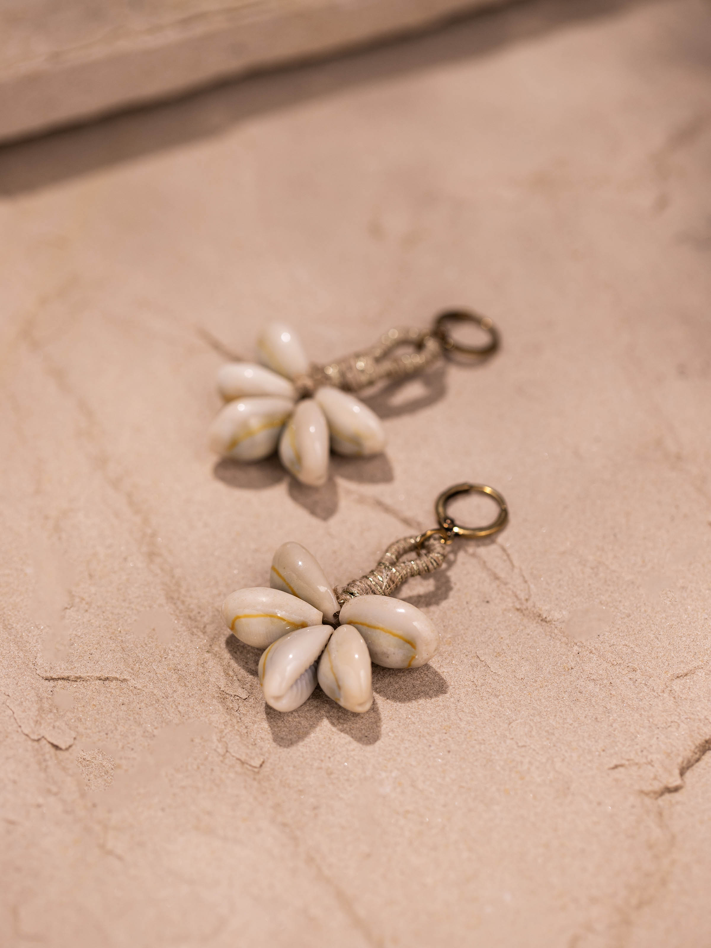 Detailed view of Cowrie Shell Drop Earrings focusing on the craftsmanship and shell texture.