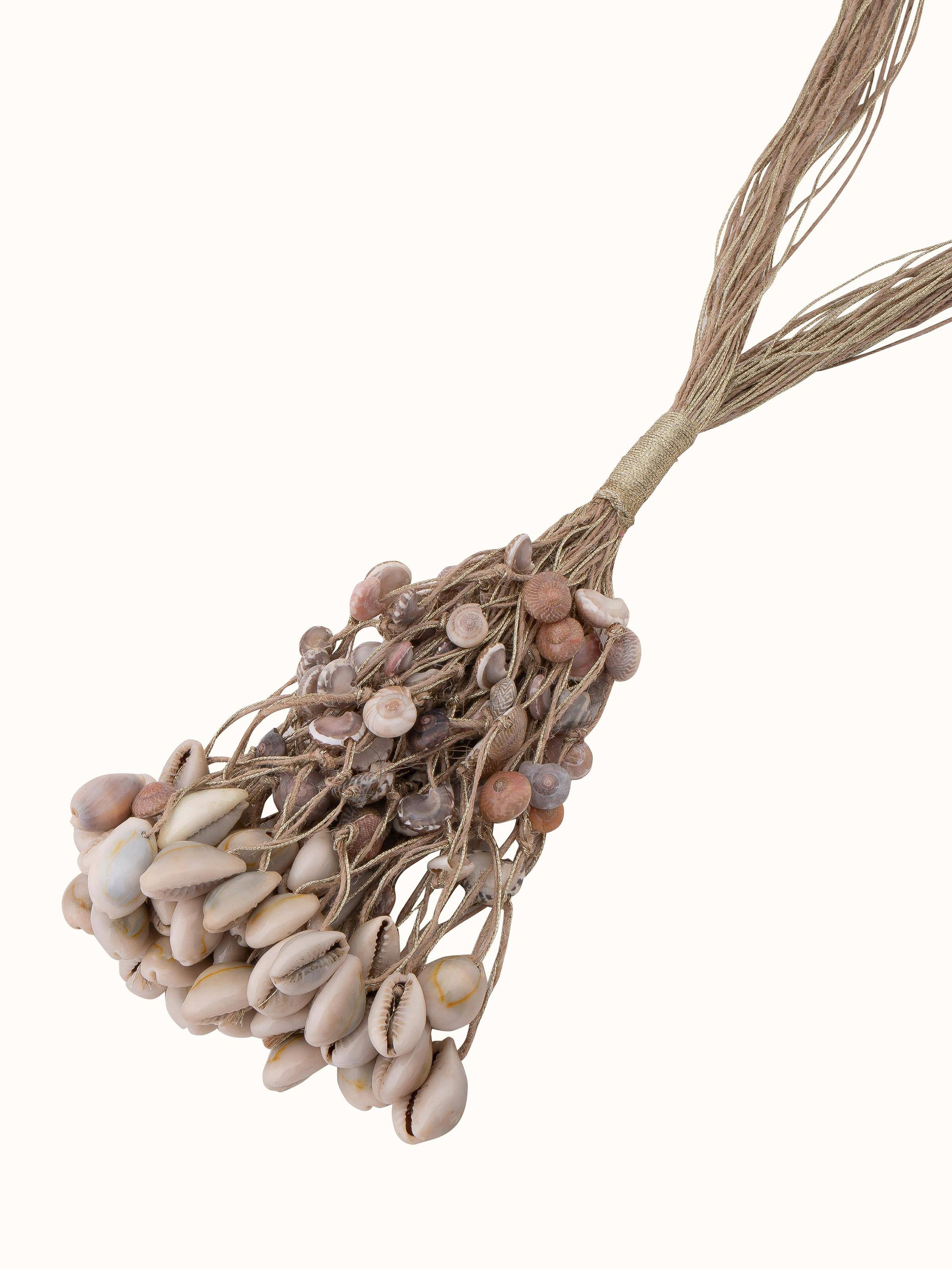 "Overhead view of cowrie shell long necklace showcasing overall design"