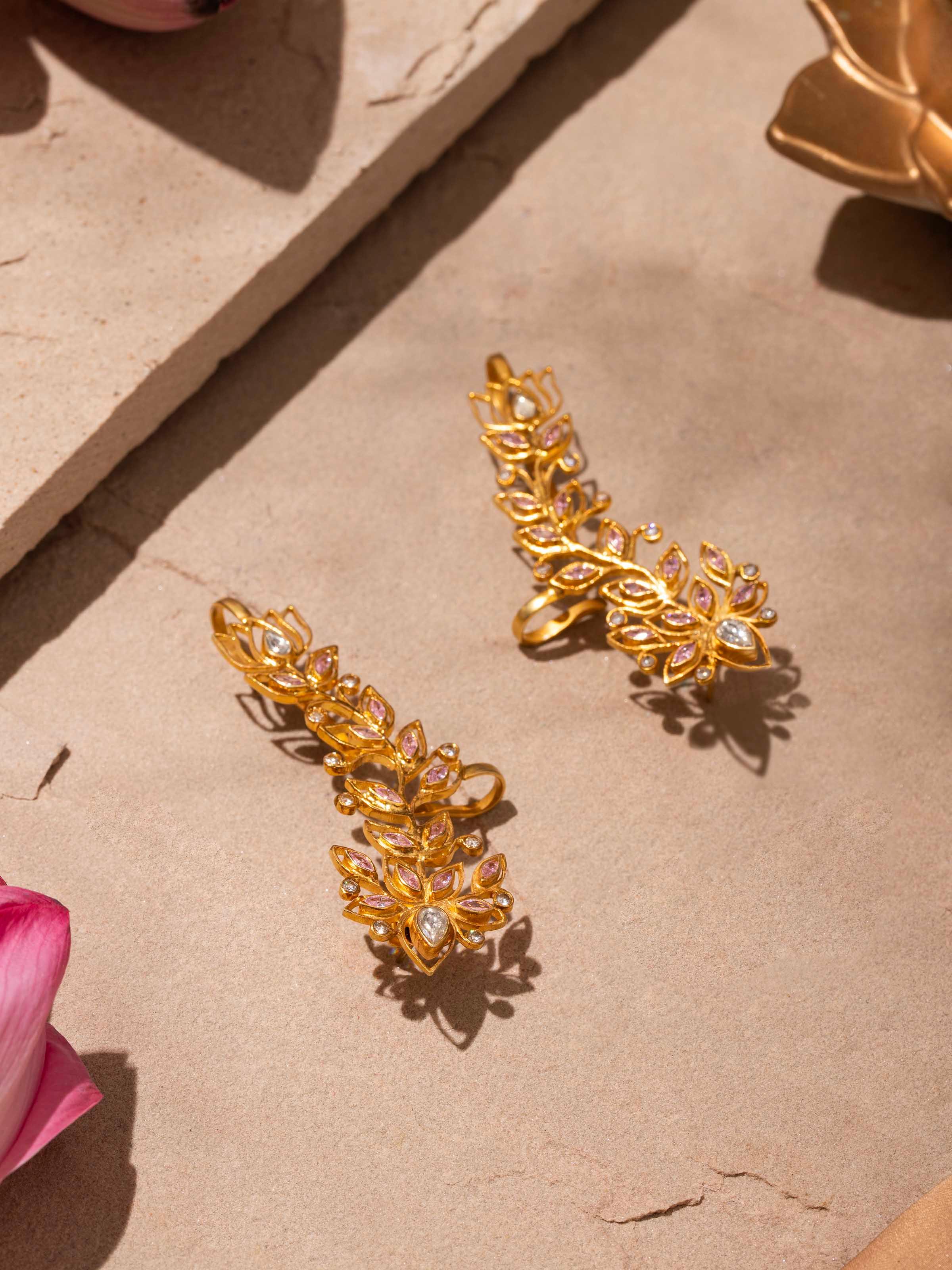 Close-up view of silver smithing ear cuffs emphasizing fine details and artisanal craftsmanship.