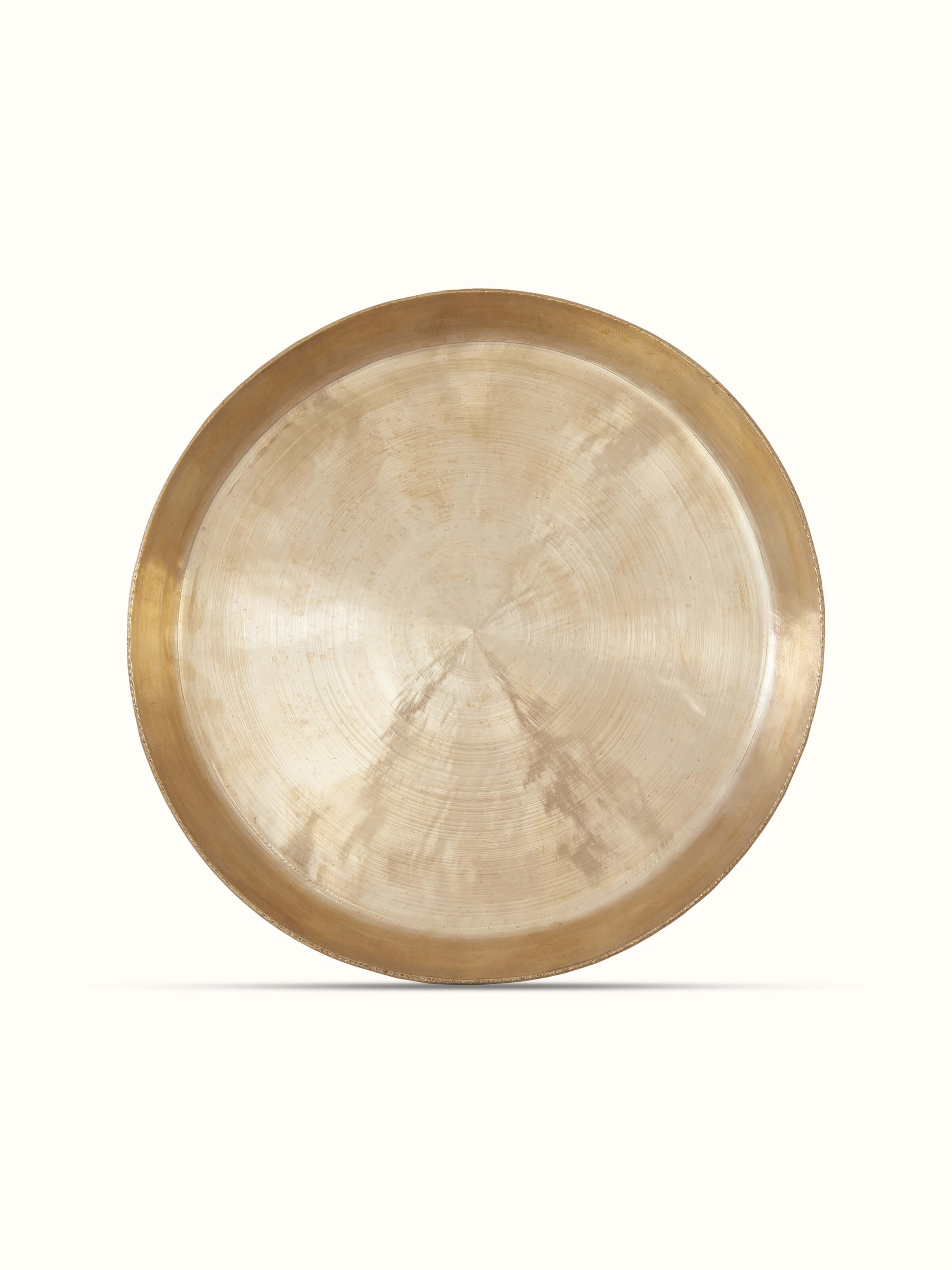 Side view of bell metal salad plate, emphasizing the smooth finish and metallic shine