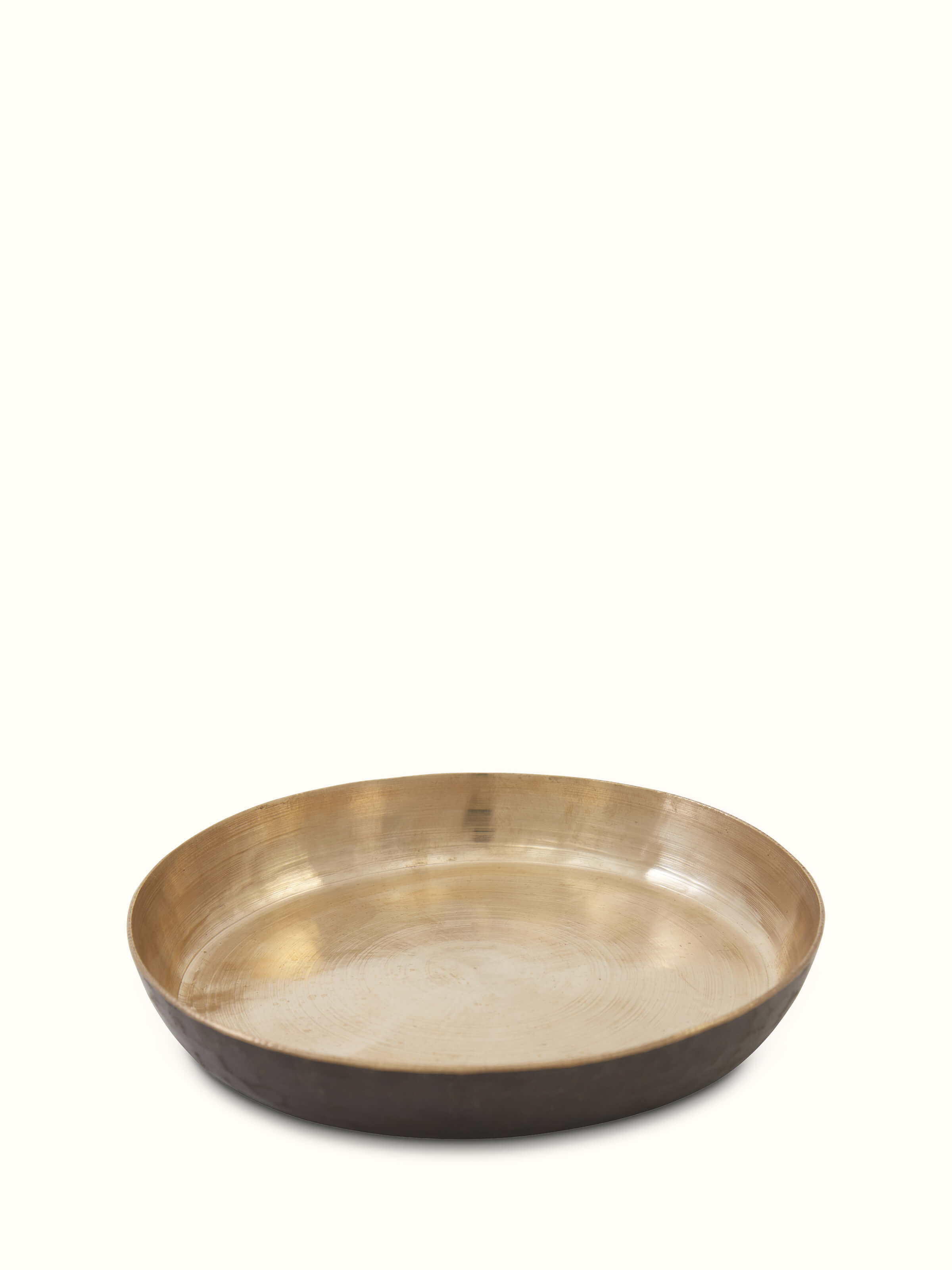 Detailed view of bell metal salad plate, highlighting the craftsmanship and reflective surface