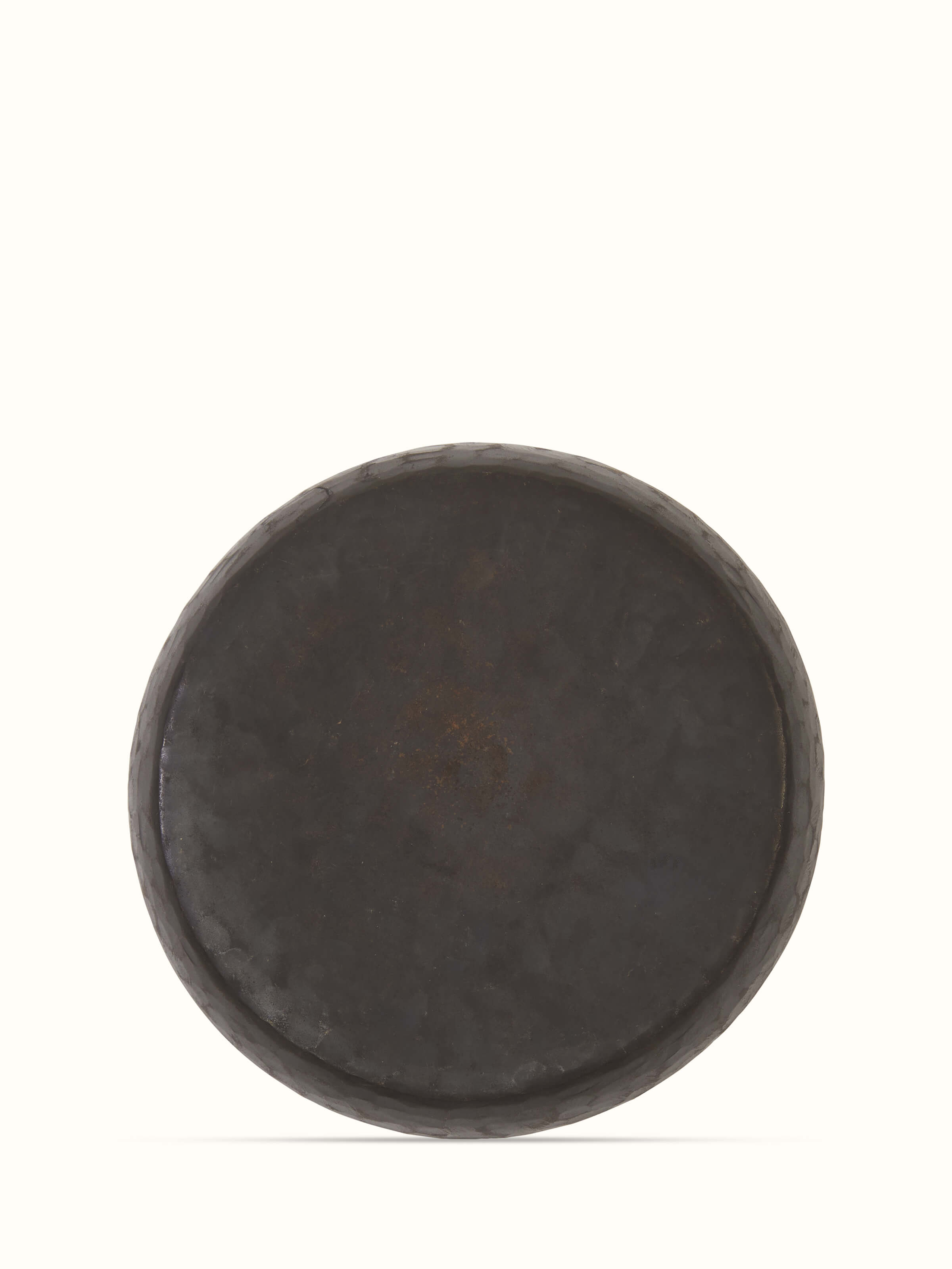 Angle view of bell metal salad plate, highlighting its design and metallic sheen